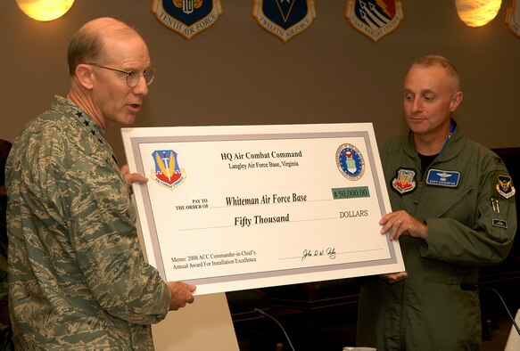 Left to right: Gen. John Corley, Air Combat Command commander with headquarters at Langley Air Force Base, Va., presents a check for $50,000 to Col. Garrett Harencak, 509th Bomb Wing commander, at the ACC commander’s conference Oct. 12. Whiteman received the money in recognition of being named ACC’s runner-up in the 2008 Commander in Chief’s Installation Excellence Award installation category. The money will be used for quality of life improvements.  (U.S. Air Force photo/Senior Airman Cecil McCloud)