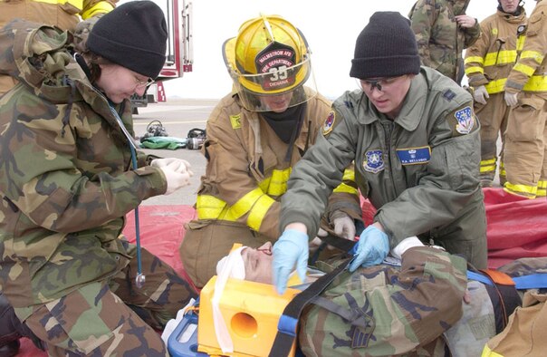 Capt. Holli Bellusci, 341st Medical Operations Squadron clinical nurse, far right, works side-by-side with other medical and fire protection personnel on a simulated injury during a Readiness Inspection in 2006. Captain Bellusci was awarded the only "honorable mention" for her nomination as a "Woman to Watch" in the 18- to 34-year-old age category at the What Women Want Expo Oct. 12 to 13 in Great Falls, Mont. (U.S. Air Force photo). 
