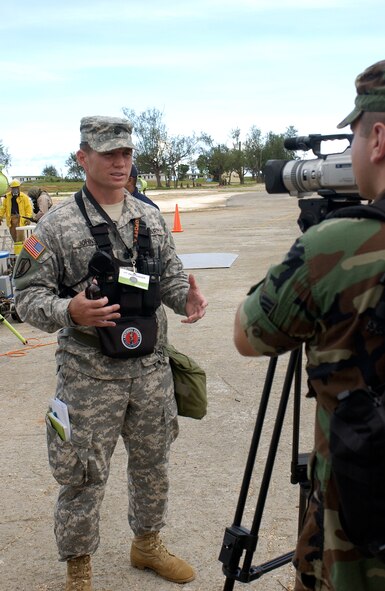 Lieutenant Colonel Trey Johnson, 93d Civil Support Team Commander from the Hawaii National Guard, gives a brief description on his role in the Topoff 4 Exercise being conducted from 15-19 October. Topoff 4, (T4), is a Congressionally mandated, terrorism preparedness exercise, involving top officials at every level of government, as well as representatives from the international community and private sector. Sponsored by the Department of Homeland Security (DHS), Topoff 4 is the fourth exercise in the Topoff Exercise series. Each Topoff Exercise involves a two-year cycle of seminars, planning events, and exercises culminating in a full-scale assessment of the nation's capacity to prevent, prepare for, respond to and recover from terrorist attacks involving Weapons of Mass Destruction (WMD). T4 uses a series of exercise activities of increasing complexity, and simulates a terrorist WMD campaign with coordinated RadiologicaL Dispersal Device (RDD), or dirty bomb attacks in the states of Arizona and Oregon, and the U.S. Territory of Guam. (USAF Photo by Senior Airman Sonya Padilla/36th Wing Public Affairs)(Released)
