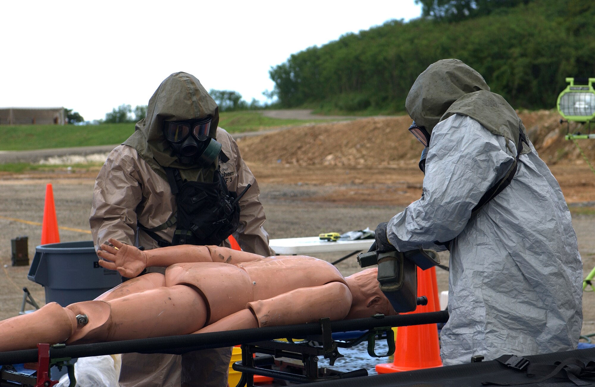 Members of the 93d Civil Support Team from the Hawaii National Guard, perform the extraction and decontamination of a dead victim after a simulated dirty bomb exploded as part of the Topoff 4 Exercise being conducted from 15-19 October. Topoff 4, (T4), is a Congressionally mandated, terrorism preparedness exercise, involving top officials at every level of government, as well as representatives from the international community and private sector. Sponsored by the Department of Homeland Security (DHS), Topoff 4 is the fourth exercise in the Topoff Exercise series. Each Topoff Exercise involves a two-year cycle of seminars, planning events, and exercises culminating in a full-scale assessment of the nation's capacity to prevent, prepare for, respond to and recover from terrorist attacks involving Weapons of Mass Destruction (WMD). T4 uses a series of exercise activities of increasing complexity, and simulates a terrorist WMD campaign with coordinated RadiologicaL Dispersal Device (RDD), or dirty bomb attacks in the states of Arizona and Oregon, and the U.S. Territory of Guam. (USAF Photo by Senior Airman Sonya Padilla/36th Wing Public Affairs)(Released)
