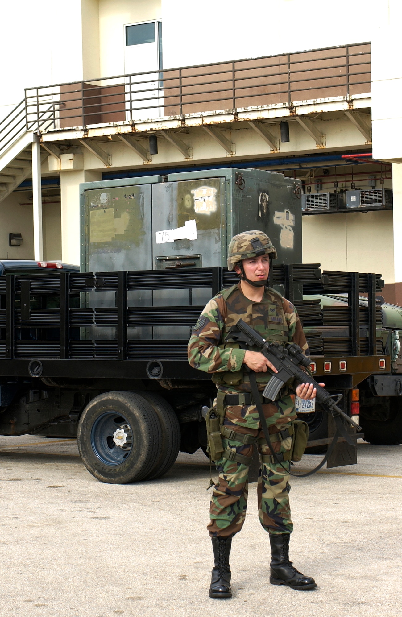 Staff Sergeant Gerald Milanez, Fire Team Leader from the 736th Contingency Response Group, stands guard for the delivery of valuable material from Andersen AFB to the Guam Memorial Hospital as part of the Topoff 4 Exercise being conducted from 15-19 October. Topoff 4, (T4), is a Congressionally mandated, terrorism preparedness exercise, involving top officials at every level of government, as well as representatives from the international community and private sector. Sponsored by the Department of Homeland Security (DHS), Topoff 4 is the fourth exercise in the Topoff Exercise series. Each Topoff Exercise involves a two-year cycle of seminars, planning events, and exercises culminating in a full-scale assessment of the nation's capacity to prevent, prepare for, respond to and recover from terrorist attacks involving Weapons of Mass Destruction (WMD). T4 uses a series of exercise activities of increasing complexity, and simulates a terrorist WMD campaign with coordinated RadiologicaL Dispersal Device (RDD), or dirty bomb attacks in the states of Arizona and Oregon, and the U.S. Territory of Guam. (USAF Photo by Senior Airman Sonya Padilla/36th Wing Public Affairs)(Released)