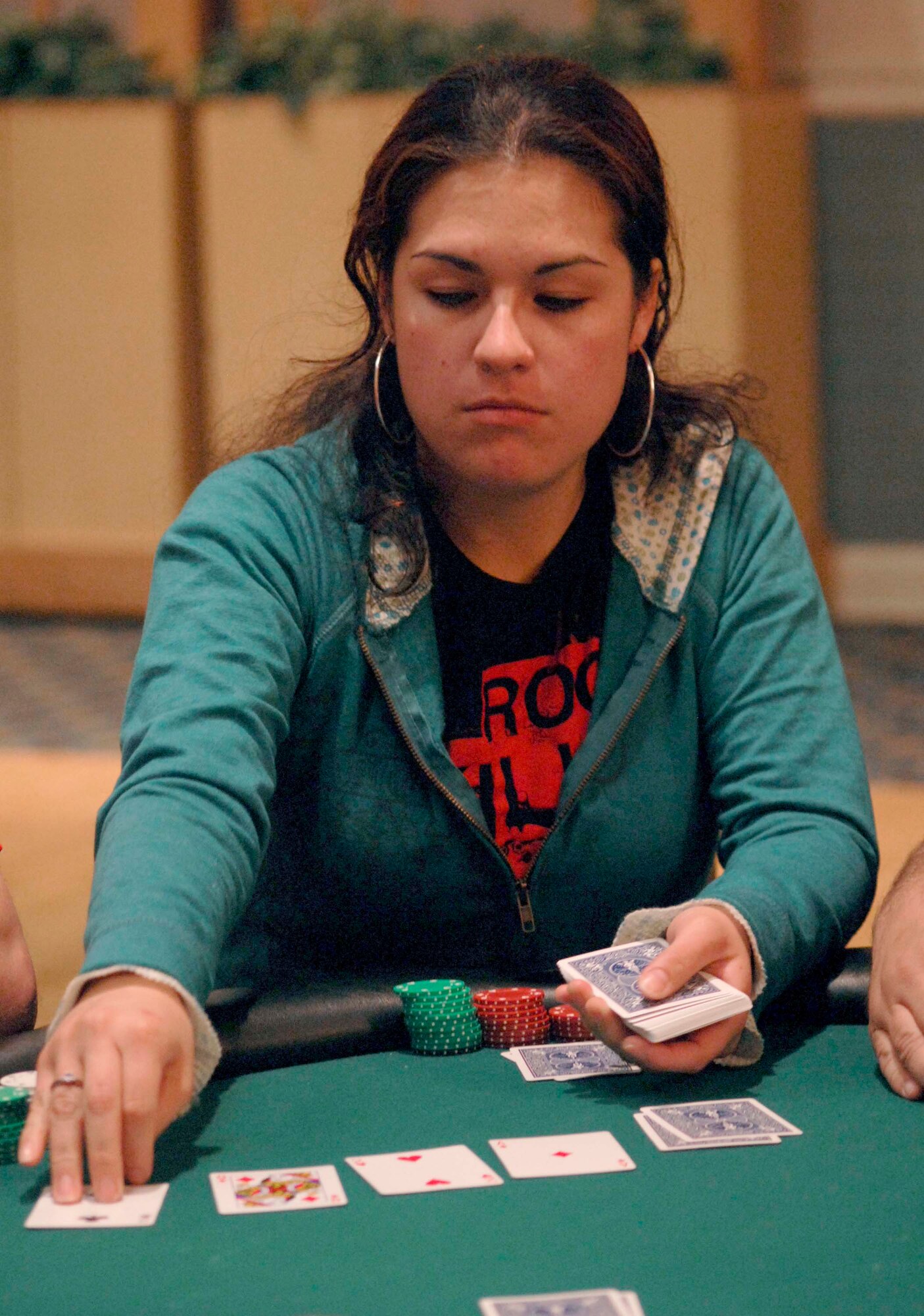 KUNSAN AIR BASE, South Korea - Senior Airman Ana Noboa, 8th Operations Support Squadron, air traffic controller, deals the "turn" card during the Texas Hold 'Em tournament here Oct. 16.  The 8th Services Squadron is holding a series of qualifying rounds every other Tuesday evening for the next month to determine the Kunsan AB Texas Hold 'Em Champion.  The Kunsan Champion will win a position at the Texas Hold 'Em Championship Showdown in Honolulu, Hawaii Jan. 23-27 with free airfare and lodging.  (U.S. Air Force photo/Staff Sgt. Darcie L. Ibidapo)