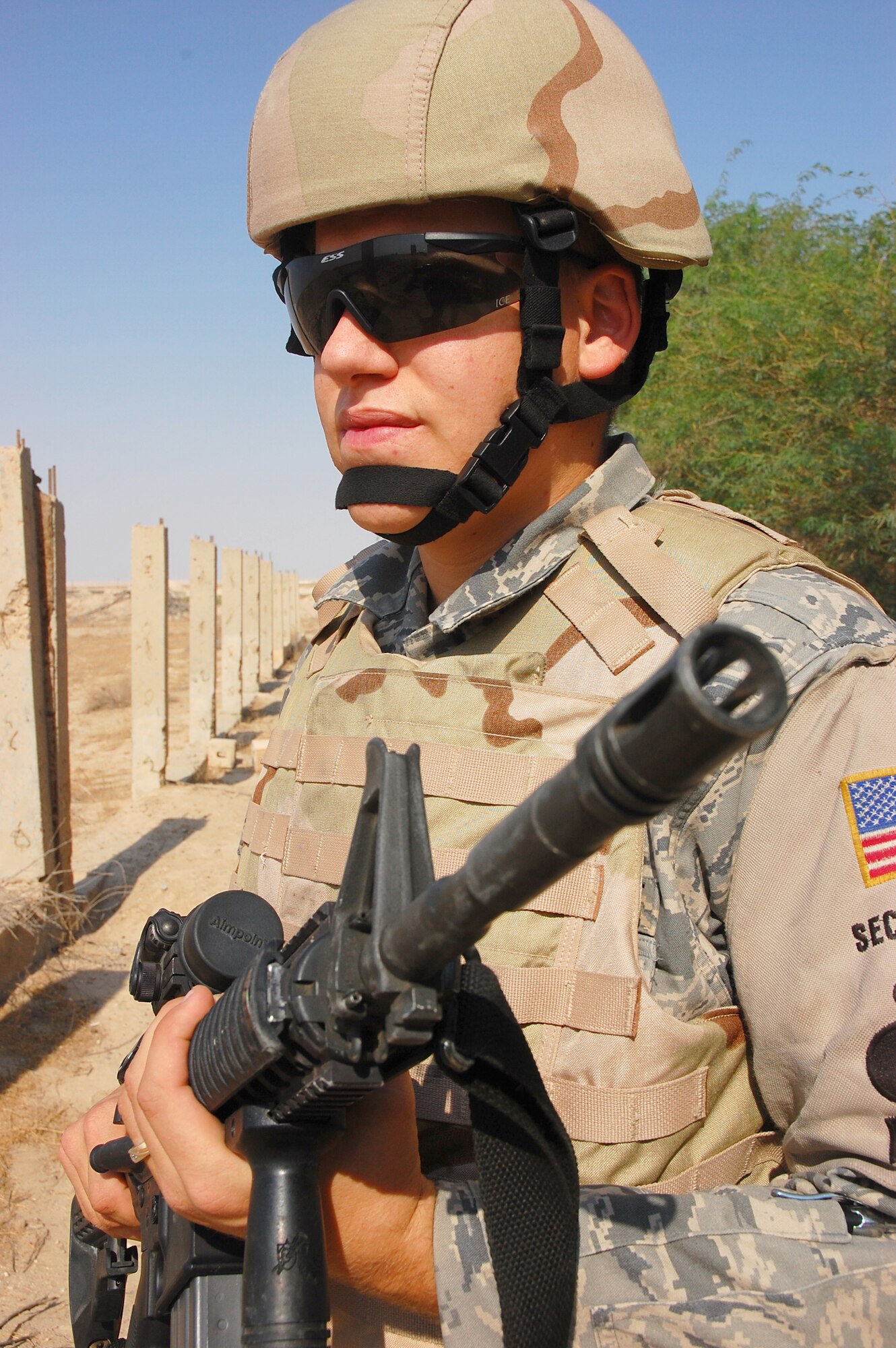 SOUTHWEST ASIA -- Airman 1st Class Christopher Michaud, 386th Expeditionary Security Forces Squadron elite entry controller, performs a security operations check at the base entry control point here Oct. 15.  Airman Michaud is from Titusville, Fla., and is deployed from Eglin Air Force Base, Fla.  (U.S. Air Force photo by Staff Sgt. Tia Schroeder)