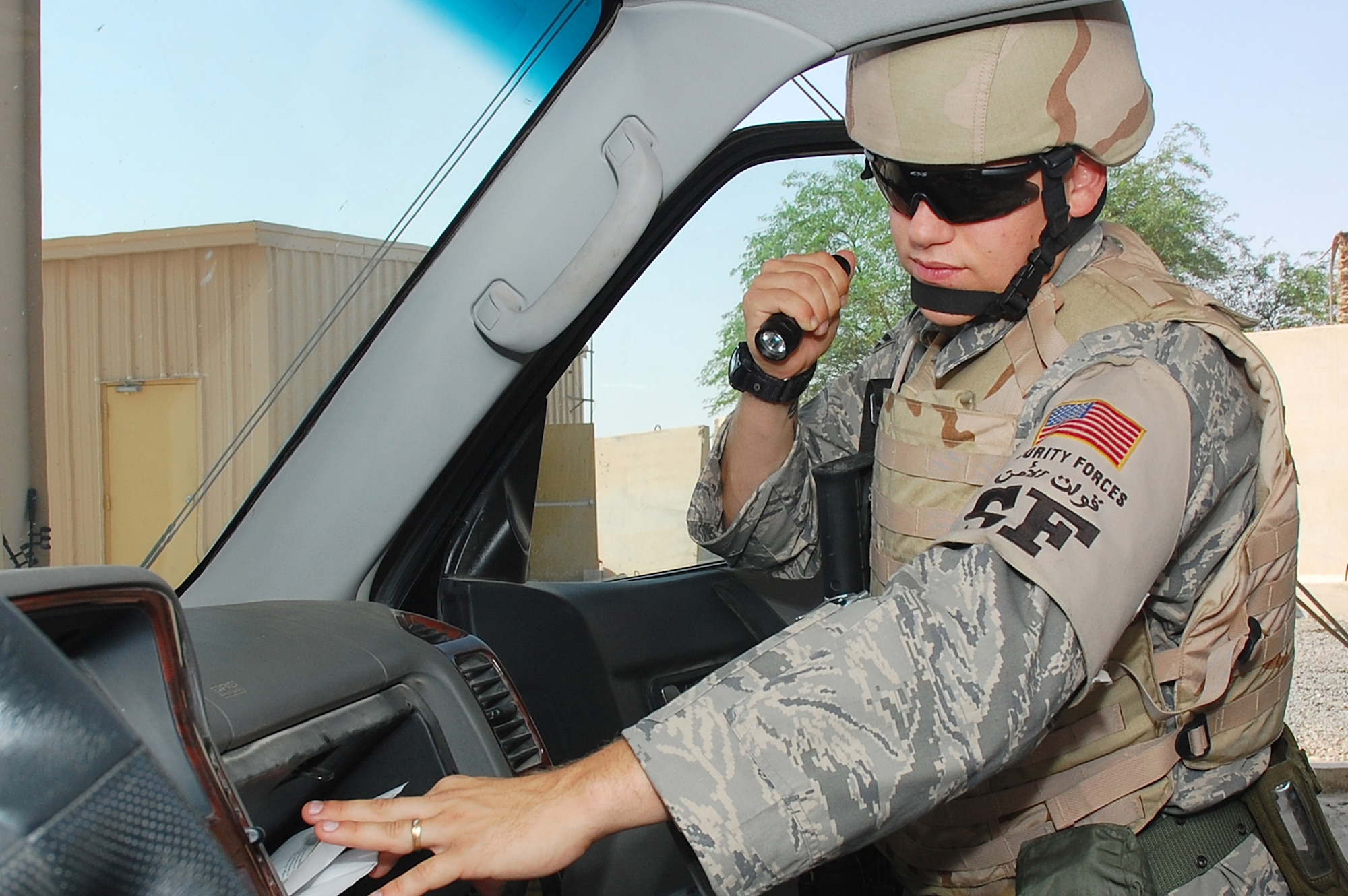 SOUTHWEST ASIA -- Airman 1st Class Christopher Michaud, 386th Expeditionary Security Forces Squadron elite entry controller, performs a security operations check on a vehicle here Oct. 15.  Airman Michaud is from Titusville, Fla., and is deployed from Eglin Air Force Base, Fla.  (U.S. Air Force photo by Staff Sgt. Tia Schroeder)