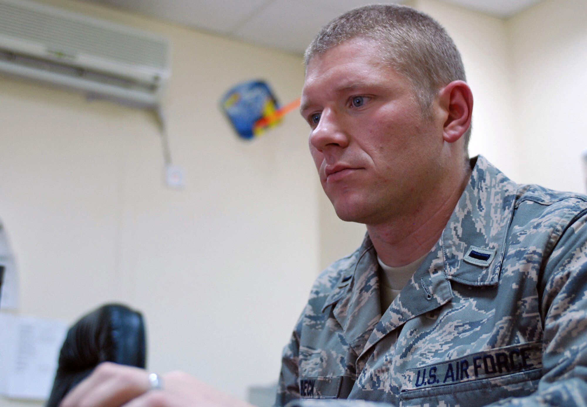BAGHDAD, Iraq - Air Force 1st Lieutenant Matthew Beck, currently assigned to the Multi-National Security Transition Command – Iraq in Baghdad, Iraq, reviews finance information on a computer. Beck works in the strategic plans and programs section of the comptroller unit at MNSTC-I. (U.S. Air Force photo by Staff Sgt. Christopher Frost)