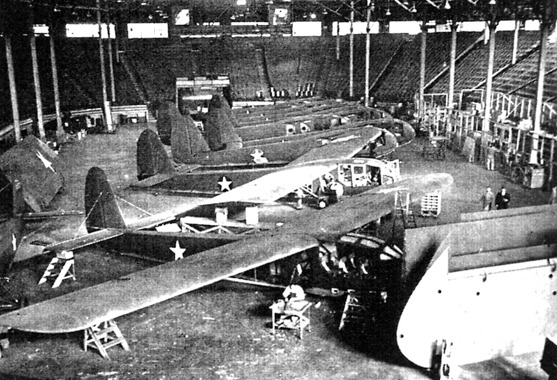 Kansas City's American Royal arena was one of several U.S. locations where the Waco CG-4A combat glider was built during World War II. Unlike the it's predecessor the CG-3A, pictured in the American Royal Arena here,  the CG-4A could not only carry troops, it was capable of carrying a jeep with a trailer, a 75-mm howitzer or a specially-made small bulldozer.  (Archive photo from the "Waco Word")