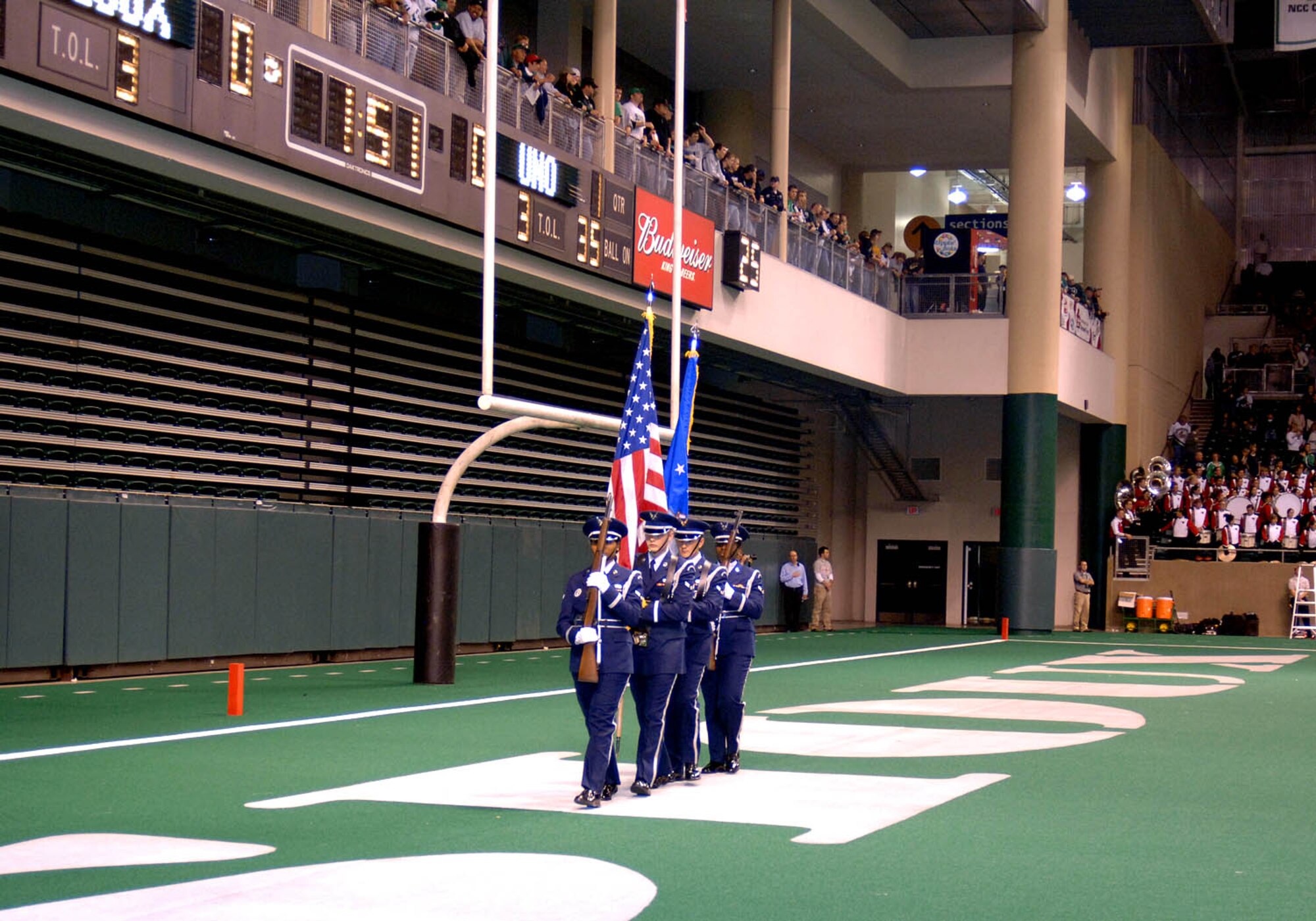 Honor Guard members from the 319th Air Refueling Wing perform color guard during the opening ceremonies at Military Appreciation Day football game between the University of North Dakota Fighting Sioux and the University of Nebraska at Omaha Mavericks in Grand Forks Oct.13. The city of Grand Forks provides many opportunities for the Air Force community to get involved in local events, one being the yearly Military Appreciation Day event. (U.S. Air Force photo/Senior Airman SerMae Lampkin)
