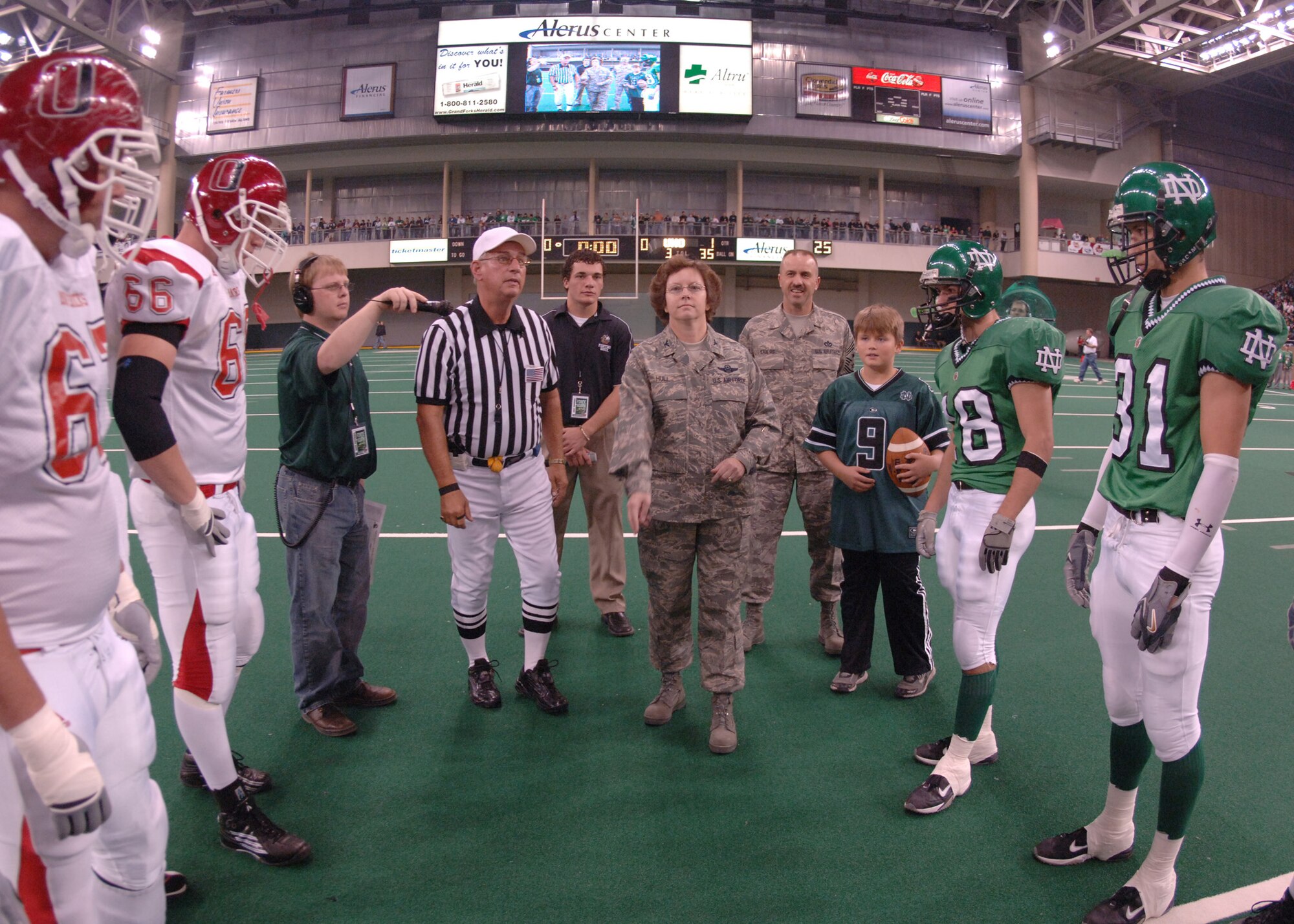 Col. Diane Hull, the 319th Air Refueling Wing commander, tosses the coin during opening ceremonies at the Military Appreciation Day football game between the University of North Dakota Fighting Sioux and the University of Nebraska at Omaha Mavericks in Grand Forks Oct. 13.  The city of Grand Forks provides many opportunities for the Air Force community to get involved in local events, one being the yearly Military Appreciation Day event.  (U.S. Air Force photo/Senior Airman Chad M. Kellum)