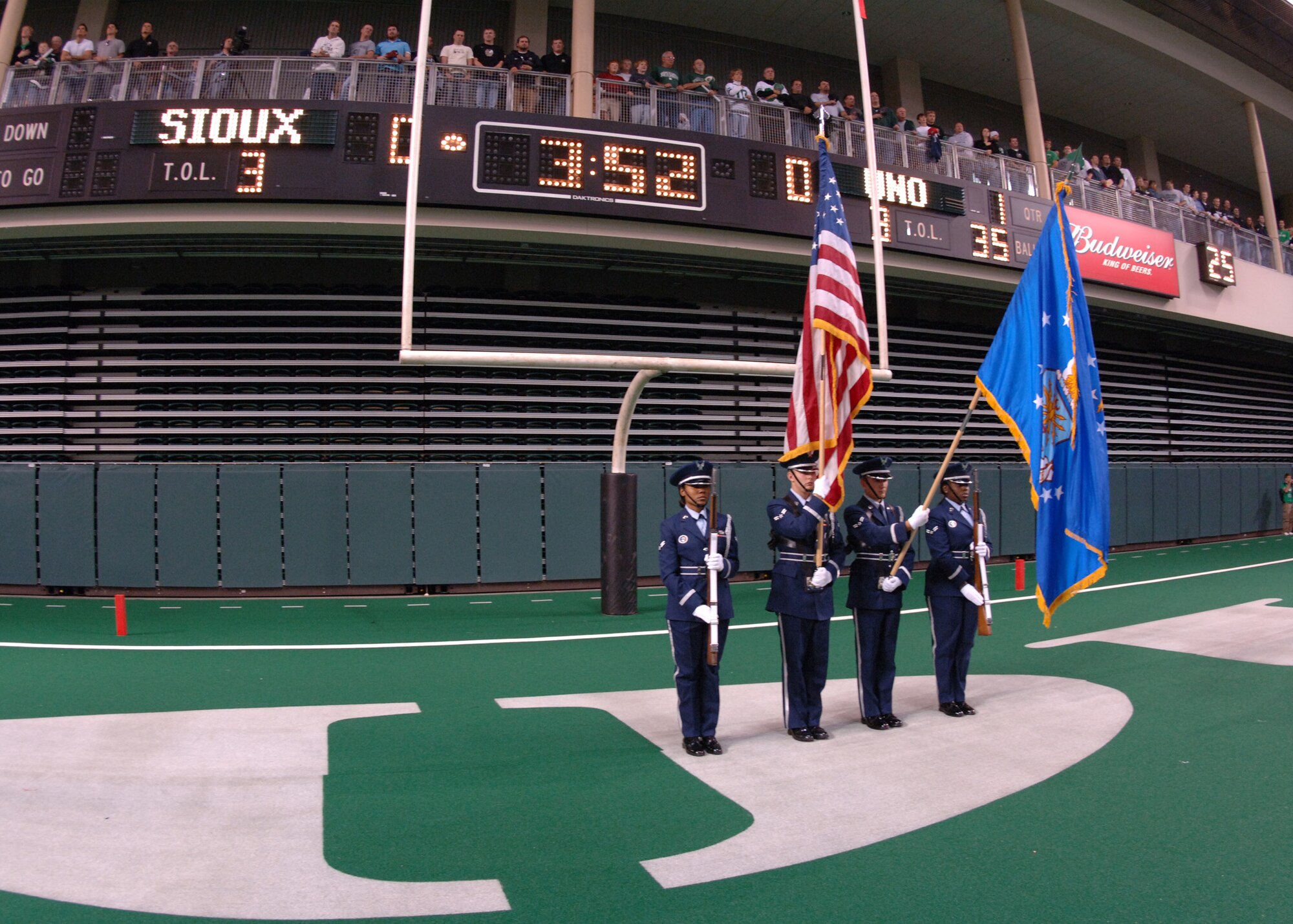 Honor Guard members from the 319th Air Refueling Wing perform color guard during the opening ceremonies at Military Appreciation Day football game between the University of North Dakota Fighting Sioux and the University of Nebraska at Omaha Mavericks in Grand Forks Oct.13. The city of Grand Forks provides many opportunities for the Air Force community to get involved in local events, one being the yearly Military Appreciation Day event. (U.S. Air Force photo/Senior Airman Chad M. Kellum)