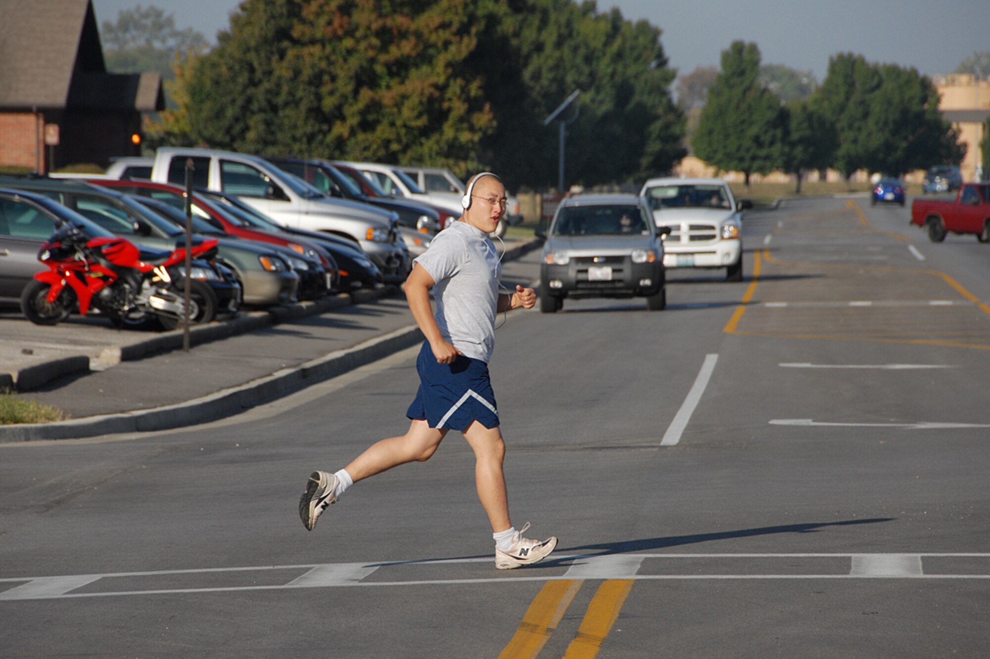 Airman 1st Class Andy Davis, 375th Airlift Wing Public Affairs journalist, uses a crosswalk during PT.