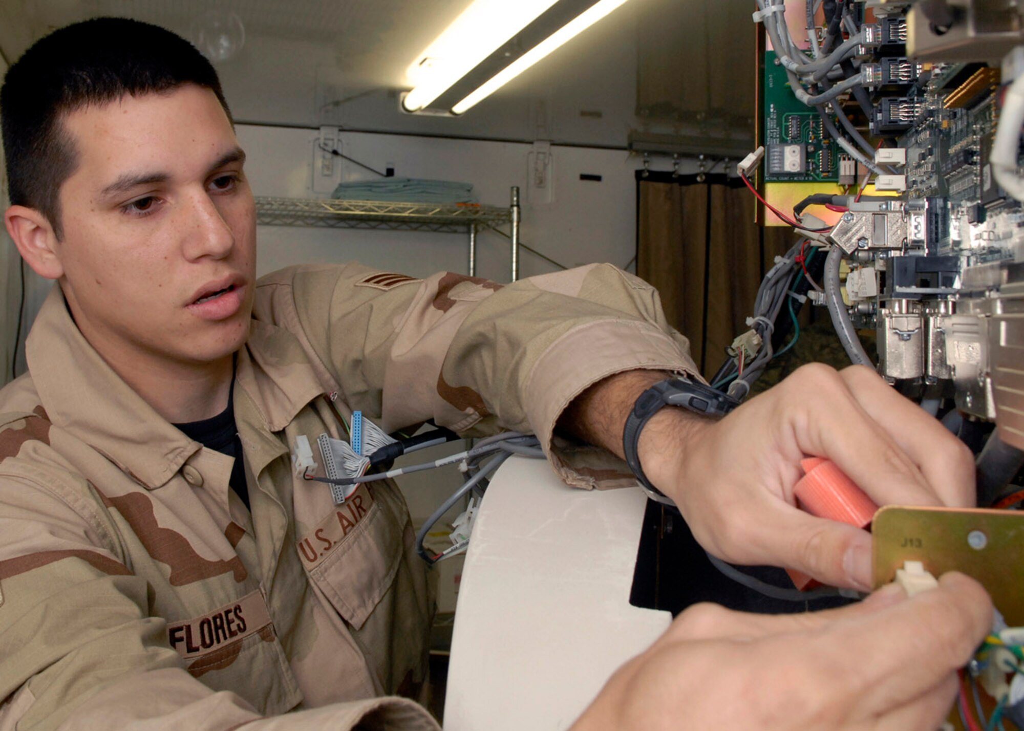 Senior Airman Bobby Flores performs preventive maintenance on a CAT scan machine Oct. 18 at the Air Force Theater Hospital at Balad Air Base, Iraq. The hospital has two CAT scans, which are vital to the diagnostic process. Airman Flores is currently deployed from Lackland Air Force Base, Texas, to the 332nd Expeditionary Medical Support Squadron. (U.S. Air Force photo/Staff Sgt. Joshua Garcia)