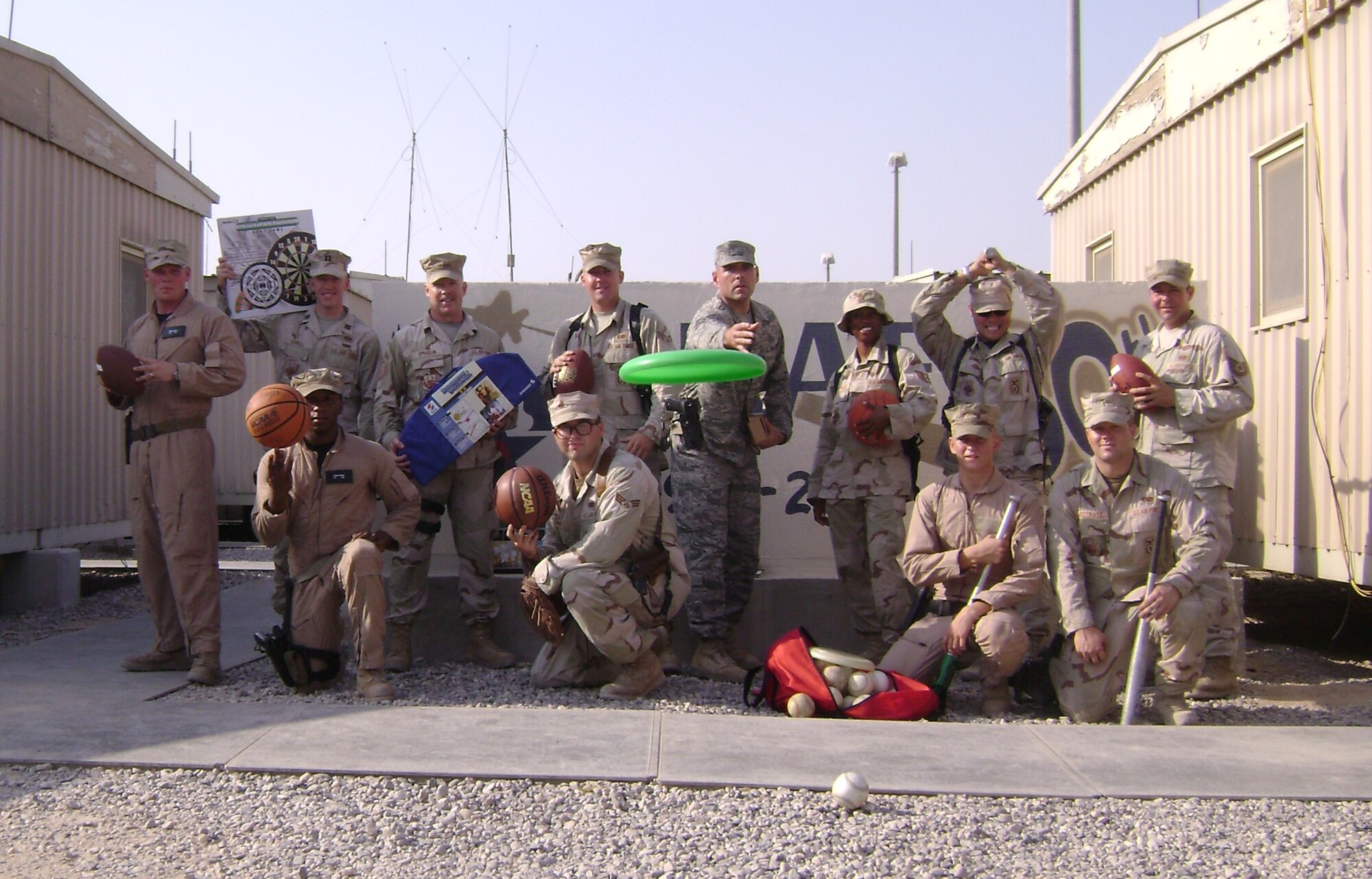 Airmen from the 586th, 886th, and 887th Security Forces Squadrons, including Senior Master Sgt. Timothy Spradlin, 445th Civil Engineer Squadron, Wright-Patterson AFB, Ohio, (standing 3rd from left) display the sports equipment which members of the wing collected and sent to them for their enjoyment while deployed down range. (Courtesy photo)
