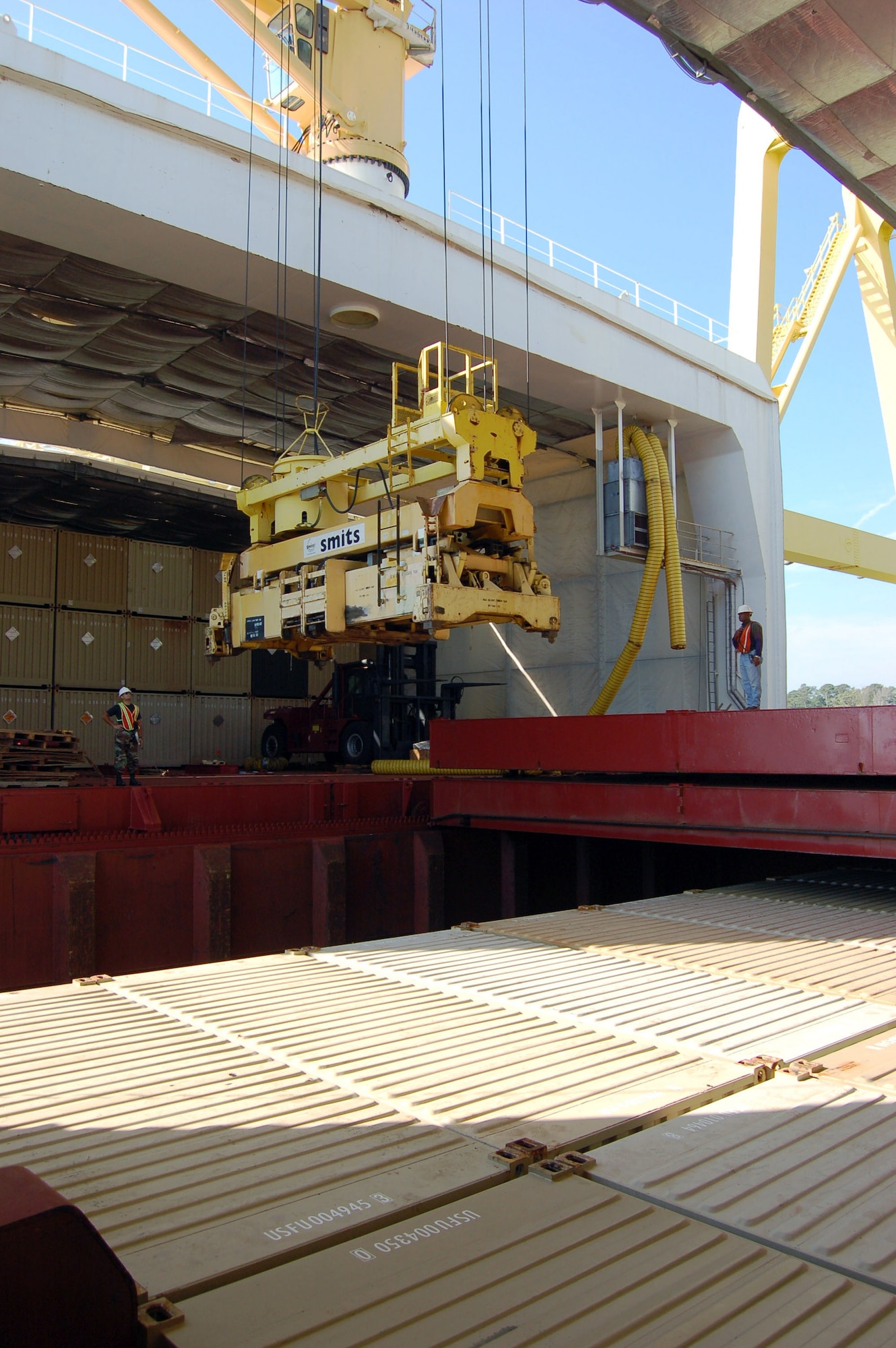 Staff Sgt. Juan Guadalupe watches as a crane prepares to unload an empty container from one of the cargo holds on the MV Capt. Steven L. Bennett, a ship belonging to the Air Force's Afloat Pre-positioned Fleet, Oct. 16 at the Military Ocean Terminal-Sunny Point, N.C. The APF ships are loaded with thousands of tons of munitions and then sail to a predetermined point in the Pacific or Indian Ocean where they wait to offload their cargo when needed. Sergeant Guadalupe is an APF team member from Tyndall Air Force Base, Fla. (U.S. Air Force photo/Staff Sgt. Matthew Bates) 
