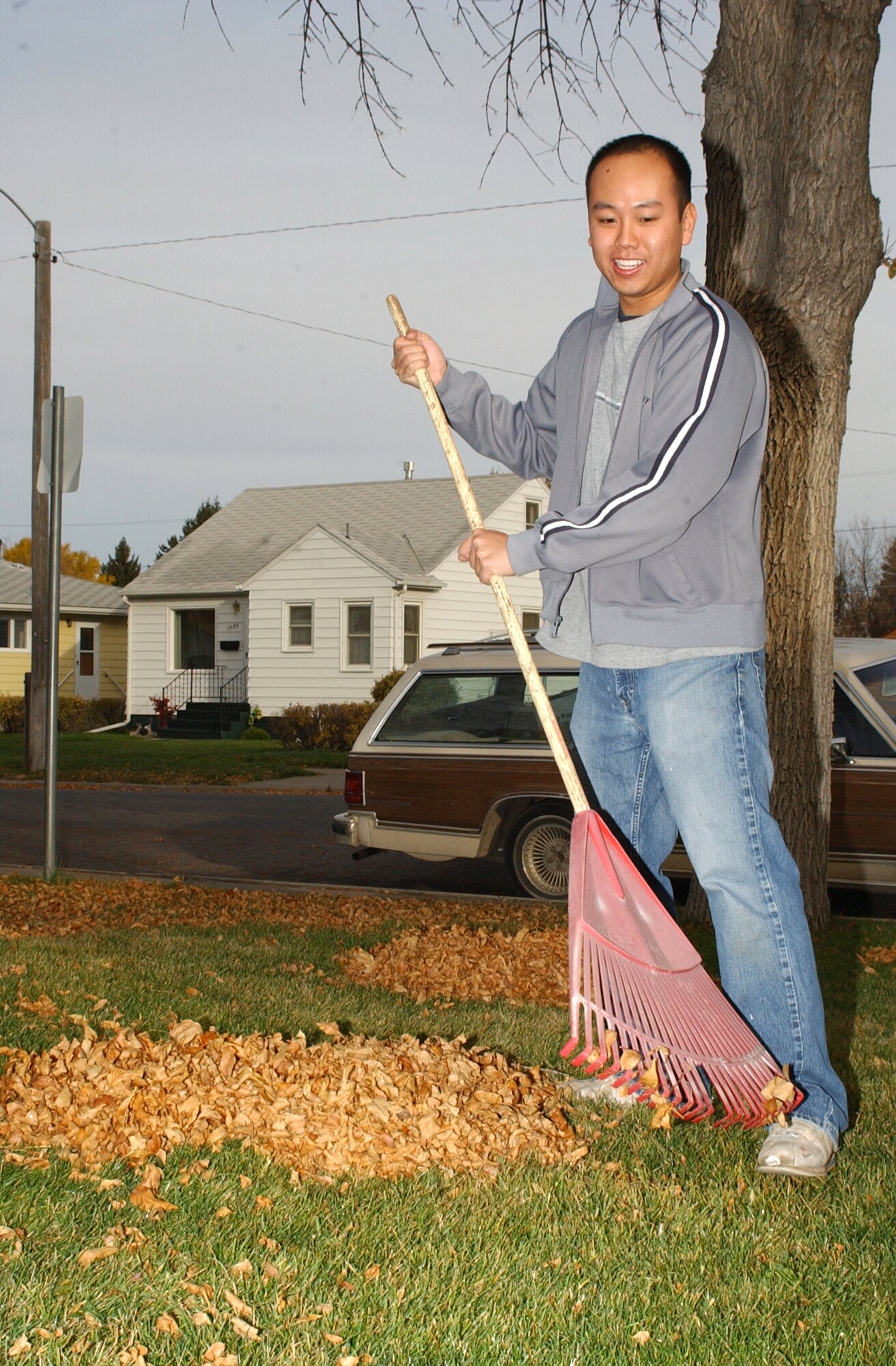 1st Lt. Harold Sham, 341st Communications Squadron, rakes leaves during the Day of Caring Oct. 12. Forty-four teams helped members of the Great Falls community doing odd jobs and yard work. The Day of Caring is supported by the Combined Federal Campaign and put on by the Great Falls Post Office (U.S. Air Force photo/Airman 1st Class Dillon White)