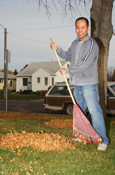 1st Lt. Harold Sham, 341st Communications Squadron, rakes leaves during the Day of Caring Oct. 12. Forty-four teams helped members of the Great Falls community doing odd jobs and yard work. The Day of Caring is supported by the Combined Federal Campaign and put on by the Great Falls Post Office (U.S. Air Force photo/Airman 1st Class Dillon White)