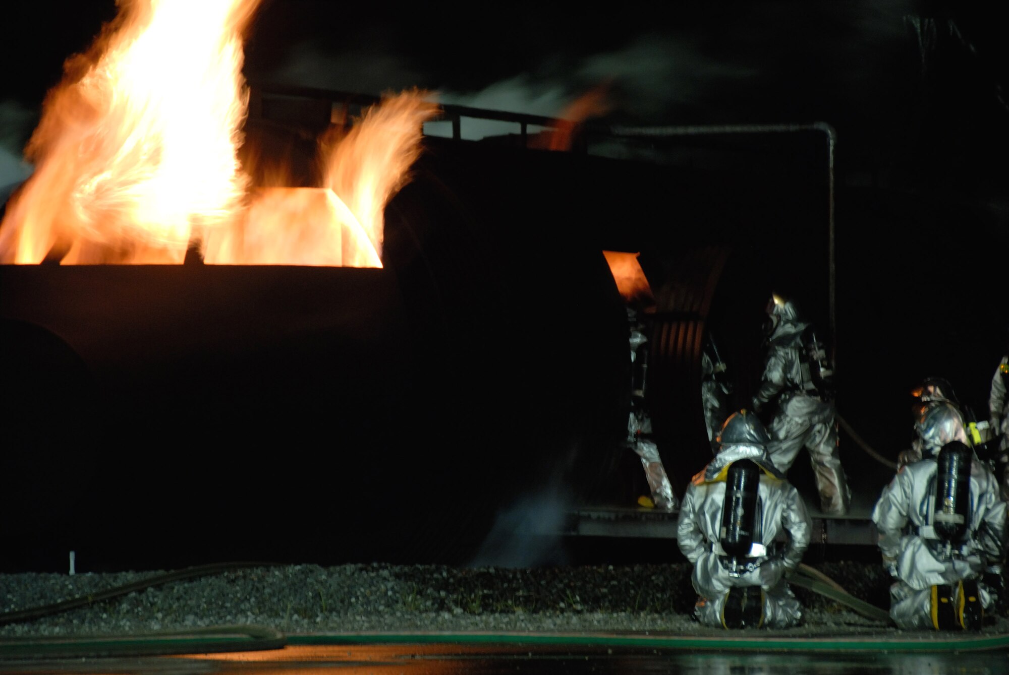 Firefighters from the 35th Civil Engineer Squadron work to put out a blaze on an aircraft fire trainer during Fire Prevention Week Oct. 9 at Misawa Air Base, Japan. The 35th CES annually demonstrates firefighting procedures for base residents. (U.S. Air Force photo/Senior Airman Laura R. McFarlane)