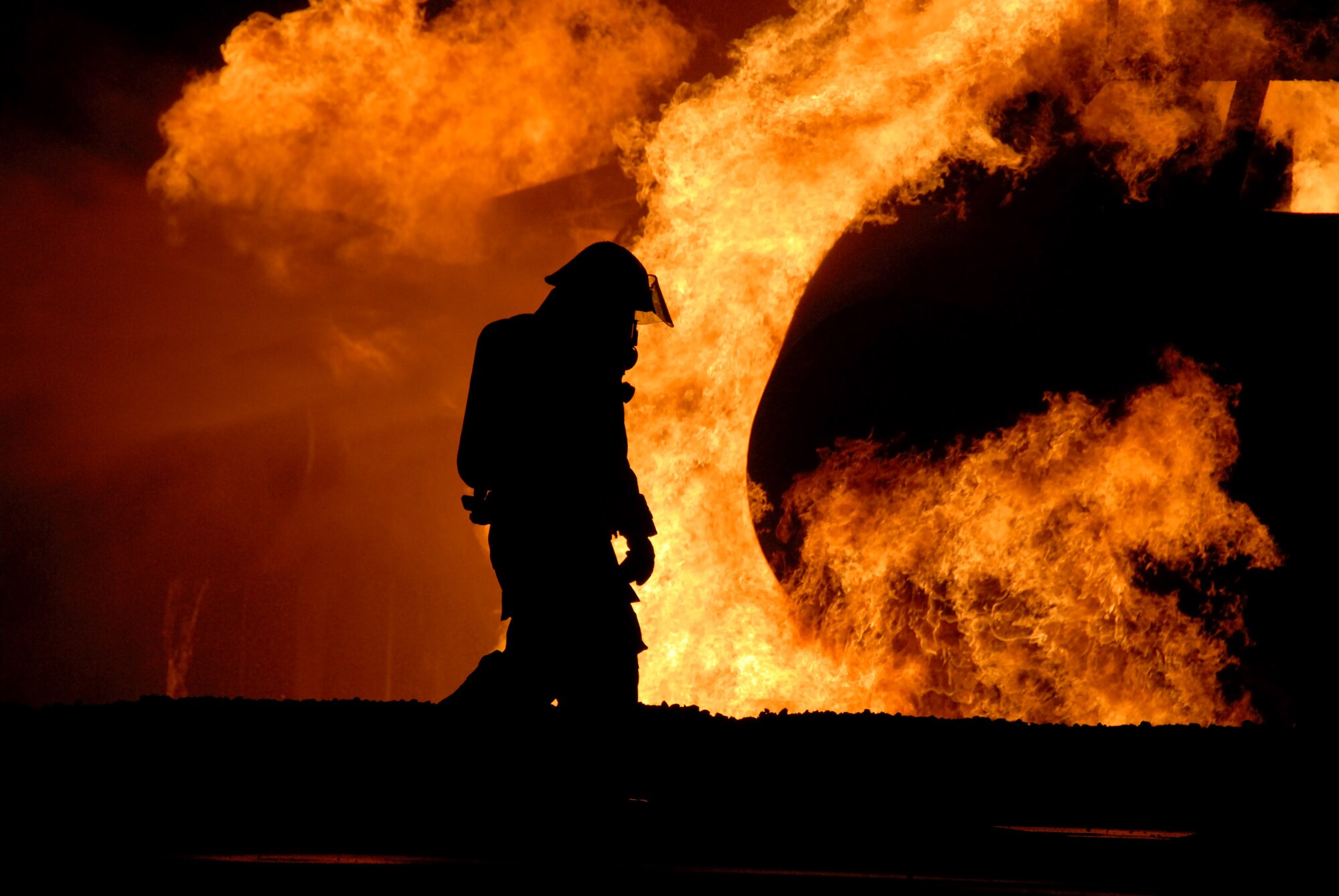 A firefighter from the 35th Civil Engineer Squadron works to put out a blaze on an aircraft fire trainer during Fire Prevention Week Oct. 9 at Misawa Air Base, Japan. The 35th CES firefighters annually demonstrate firefighting procedures for base residents. (U.S. Air Force photo/Senior Airman Laura R. McFarlane)


