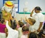 Sparky the Fire Dog and Staff Sgt. Nathaniel D. Reed, 316th Civil Engineer Squadron fire inspector, greet children at a Child Development Center visit where they talked about fire safety. (US Air Force/A1C Renae Kleckner)