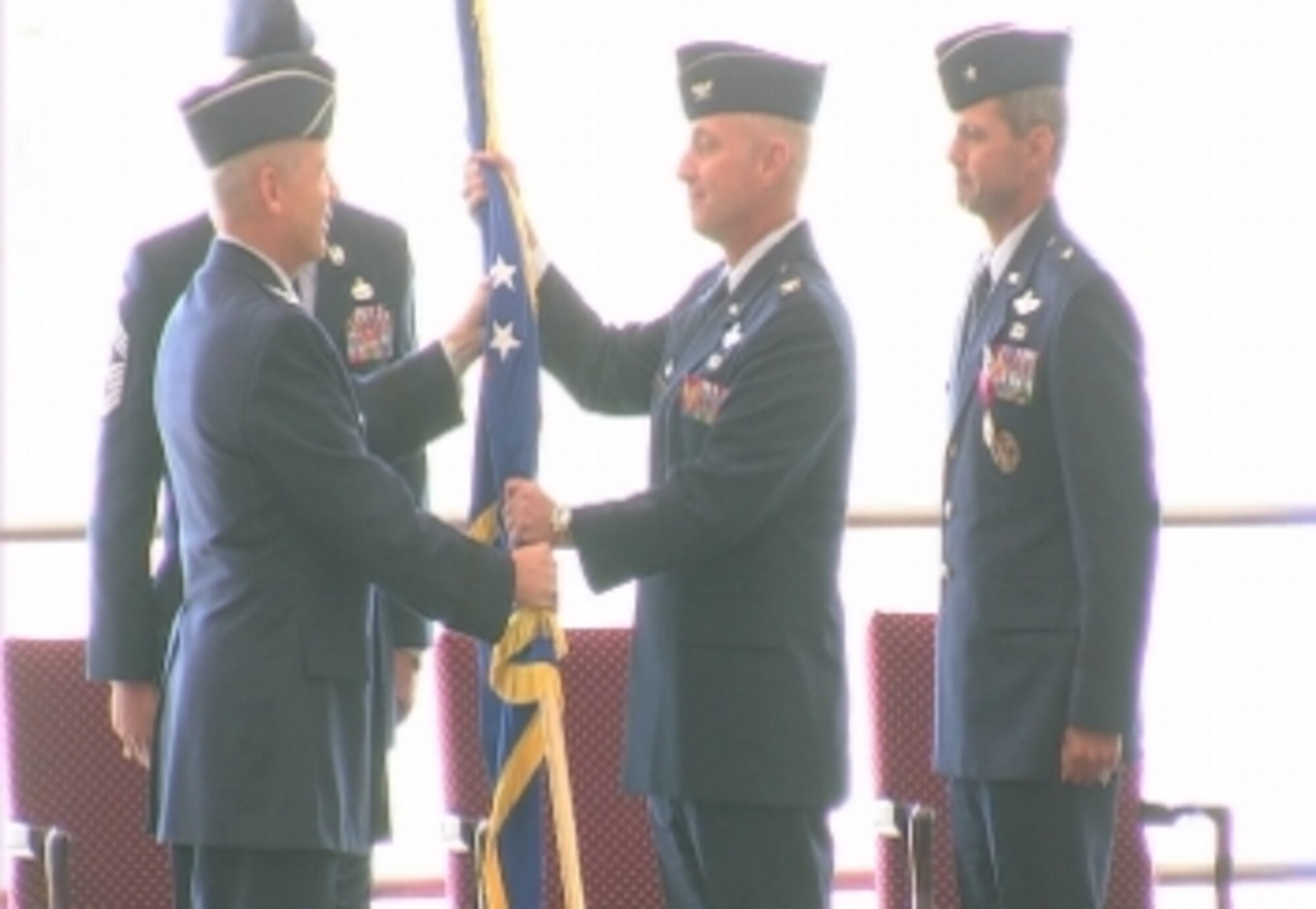 WHITEMAN AIR FORCE BASE, Mo. -- (Left to right) Lt. Gen. Robert Elder Jr., 8th Air Force commander, presents the 509th Bomb Wing guidon to Col. Garrett Harencak as Brig. Gen. Greg Biscone stands at attention during the 509th Bomb Wing change-of-command ceremony Sept. 14. Colonel Harencak took command of the 509th BW from General Biscone during the ceremony. General Biscone travels to MacDill Air Force Base, Fla., to become the deputy commander of Operations at U.S. Central Command. (U.S. Air Force photo/Staff Sgt. Felicia Haecker)   