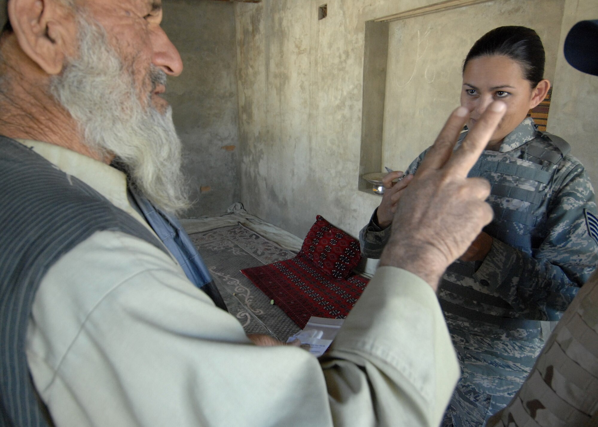 BAGRAM AIRFIELD, Afghanistan - Tech. Sgt. Joy Flumerfelt, an Air Force medical technician with the 455th Air Expeditionary Wing,  provides medical care to a small village outside of here Oct. 4, 2007.  (U.S. Air Force photo/Staff Sgt. Joshua T Jasper)(Released)