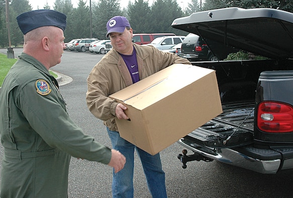 Master Sgt. Terry Acton (left), a Reservist with the 728th Airlift Squadron, McChord Air Force Base, Wash., and Bret Frye, a Starbucks manufacturing manager, unload the last of a shipment of Starbucks coffee to be delivered to troops overseas. Together, the two have given to servicemembers what they estimate to be at least 10,000 pounds of Starbucks coffee, plus an untold amount of accessories, over the last four years. (U.S. Air Force photo/Staff Sgt. Nick Przybyciel)