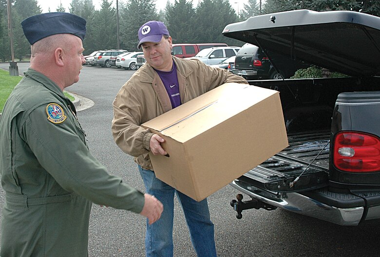 Master Sgt. Terry Acton (left), a Reservist with the 728th Airlift Squadron, McChord Air Force Base, Wash., and Bret Frye, a Starbucks manufacturing manager, unload the last of a shipment of Starbucks coffee to be delivered to troops overseas. Together, the two have given to servicemembers what they estimate to be at least 10,000 pounds of Starbucks coffee, plus an untold amount of accessories, over the last four years. (U.S. Air Force photo/Staff Sgt. Nick Przybyciel)