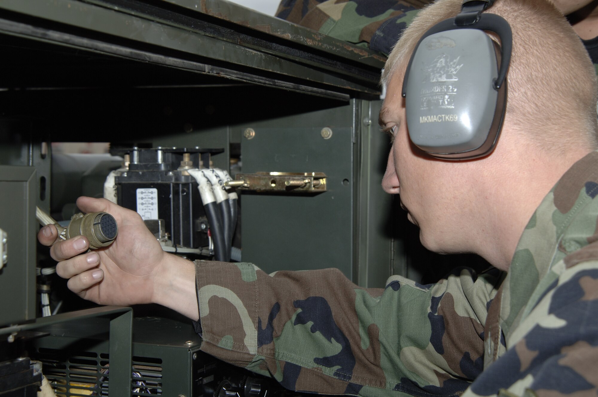 MCCONNELL AIR FORCE BASE, Kan. -- Airman 1st Class Kevin Spalding, 22 Maintenance Squadron inspects a connector for serviceability on a Hobart -86 Generator Oct. 17.  Inspecting connectors for integrity compromises help prevent shorts and overloads.  (Photo by Airman 1st Class Roy Lynch III)