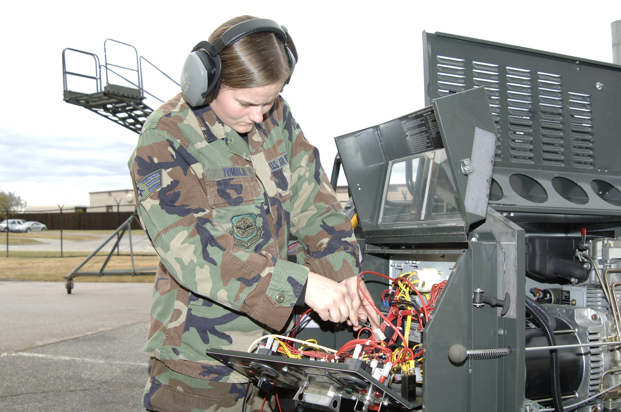 MCCONNELL AIR FORCE BASE, Kan. -- Senior Airman Rhiannon Tomblin, 184 Maintenance Squadron, repairs a connector on the new generation ground heater Oct. 17.  Repair of this connector will allow the ground heater to operate at optimum performance.  (Photo by Airman 1st Class Roy Lynch III)