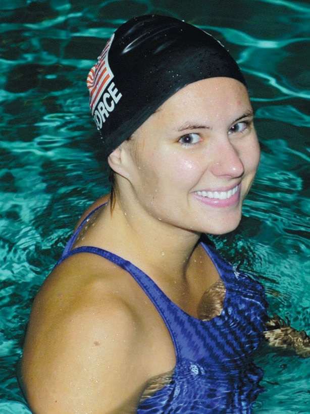 1st Lt. Sarah Brehm soaks in the pool to become comfortable with the water temperature during an early morning training session at the Mount Vernon Recreation Center in Alexandria, Va., Oct. 8. (US Air Force/Bobby Jones)