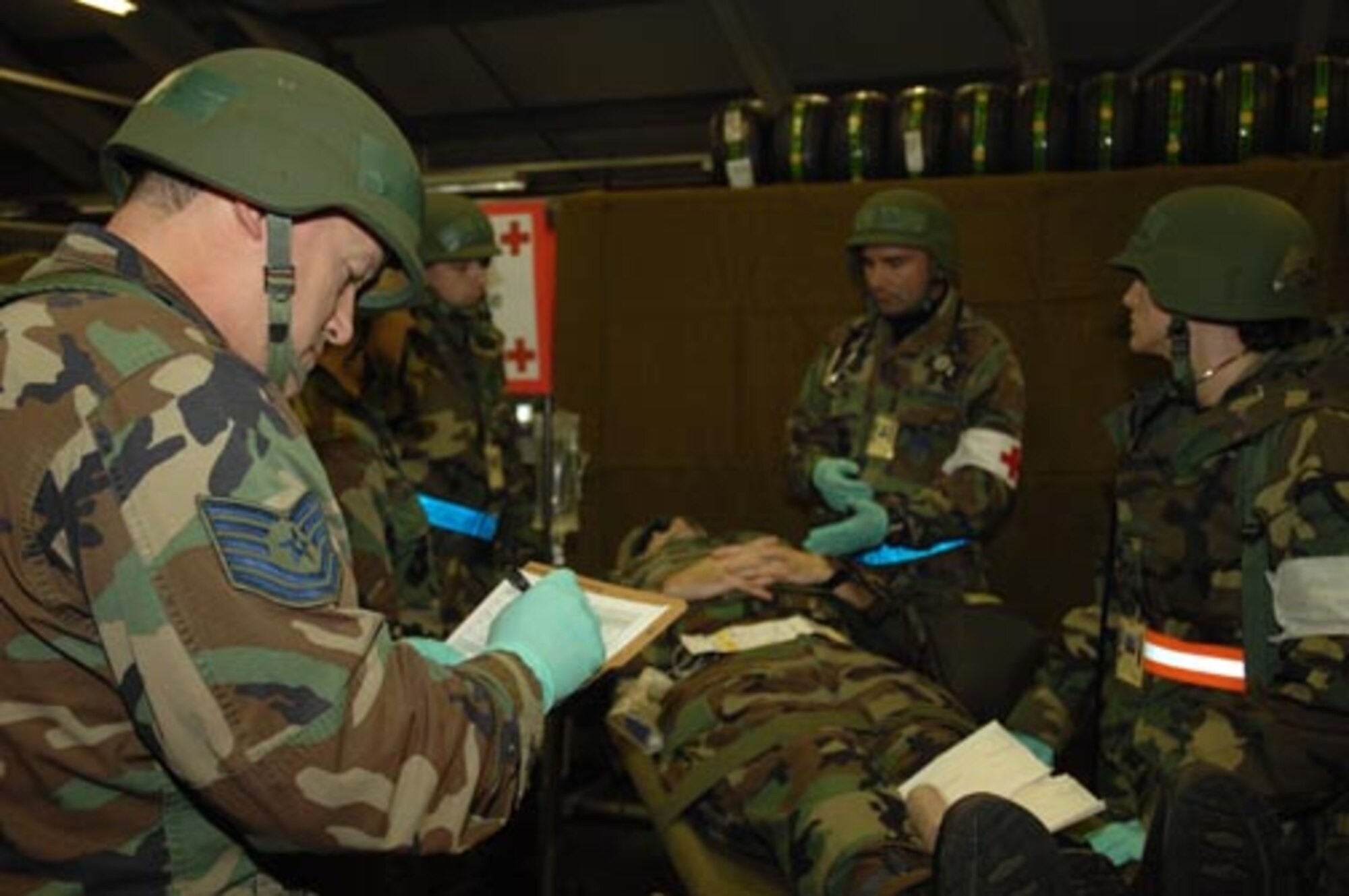 Tech. Sgt. Roy Keel fills out a medical chart at the casualty collection point during a local NATO Tactical Evaluation Exercise on Oct. 17. (U.S. Air Force photo by Airman 1st Class John Easterling)