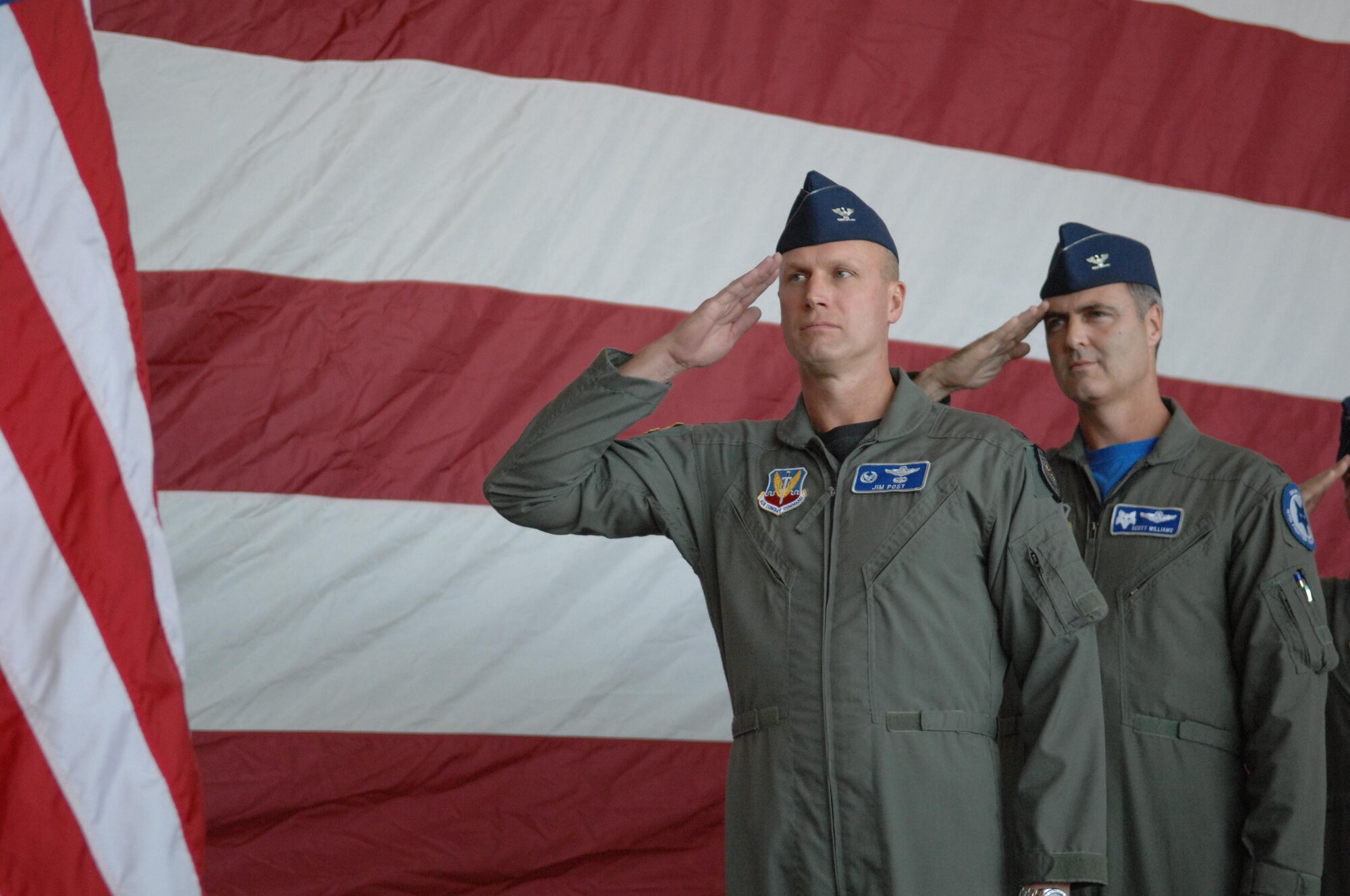 MCENTIRE JOINT NATIONAL GUARD BASE, S.C. -- Colonel James Post, 20th Fighter Wing commander and Colonel Scott Williams, 169th Fighter Squadron, salute the American flag during the ceremonial signing of the Memorandum of Understanding between Shaw and McEntire October 13, 2007. The memorandum is the document which details the support provided by Shaw to McEntire, which includes pilots and maintenance personnel. (US Air Force photo/Staff Sgt. Josef Cole III)