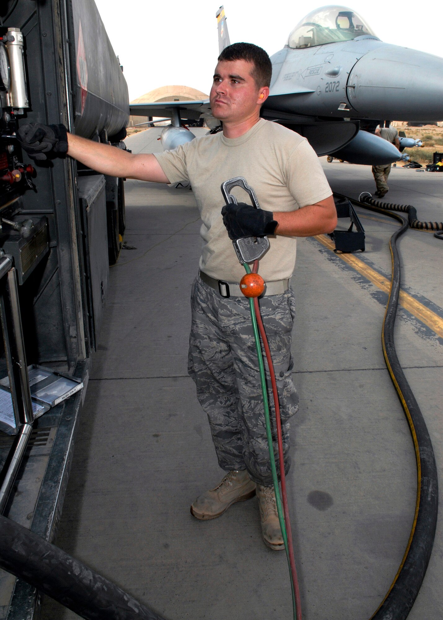 Senior Airman Joshua Maag monitors how much fuel is being pumped into an F-16 Fighting Falcon Oct. 17 at Balad Air Base, Iraq. The 332nd Expeditionary Logistics Readiness Squadron provides fuel for all aircraft and generators here. Airman Magg is asigned to the 332nd ELRS and is deployed from the 314th Logistics Readiness Squadron at Little Rock Air Force Base, Ark. (U.S. Air Force photo/Staff Sgt. Joshua Garcia) 
