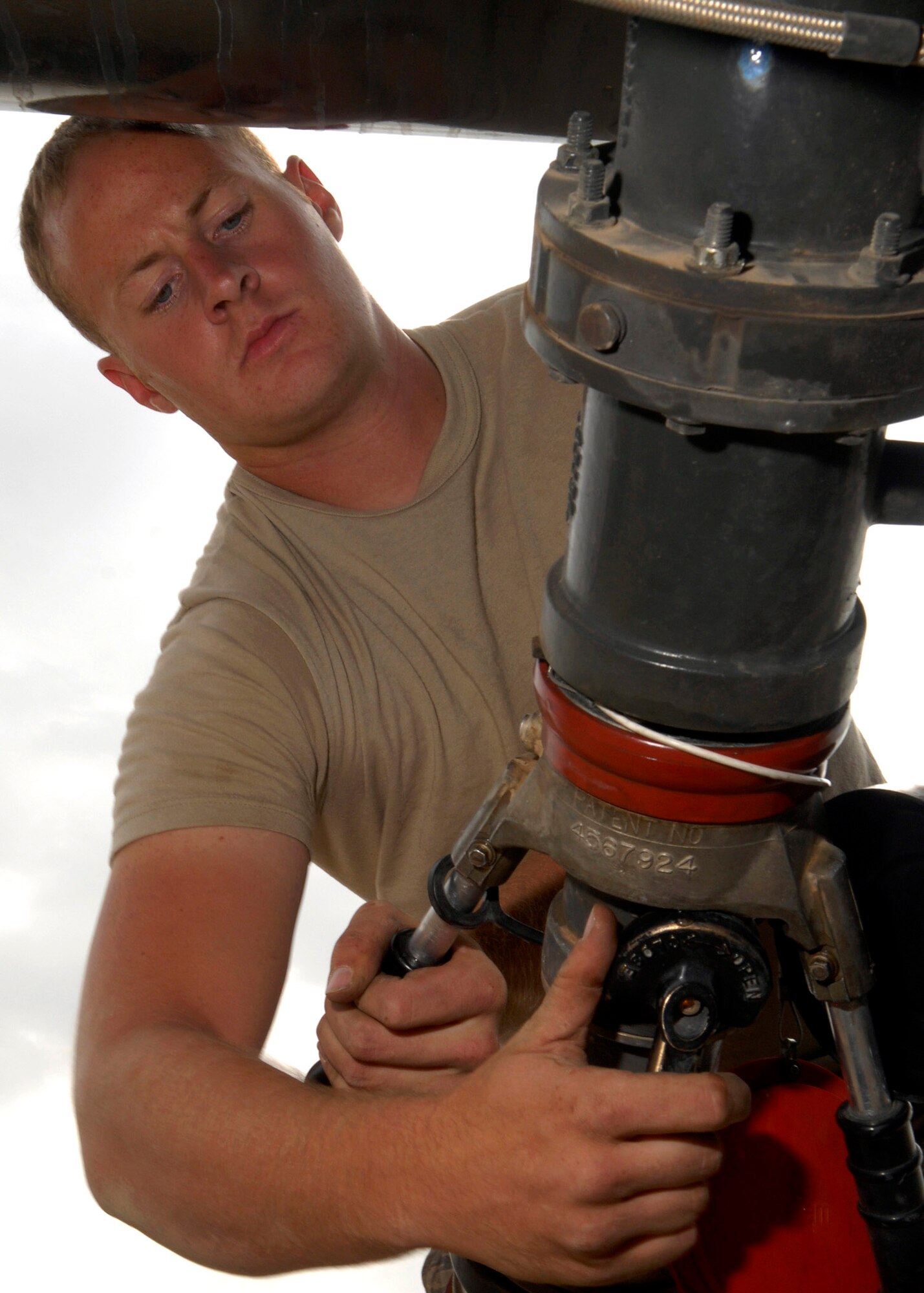 Senior Airman Justin Collins connects a pump to transfer fuel from a storage cell to a refueling truck Oct. 17 at Balad Air Base, Iraq. The 332nd Expeditionary Logistics Readiness Squadron provides fuel for all aircraft and generators here. Airman Collins is assigned to the 332nd ELRS and is deployed from Little Rock Air Force Base, Ark., where he is a member of the 314th Logistics Readiness Squadron.(U.S. Air Force photo/Staff Sgt. Joshua Garcia)