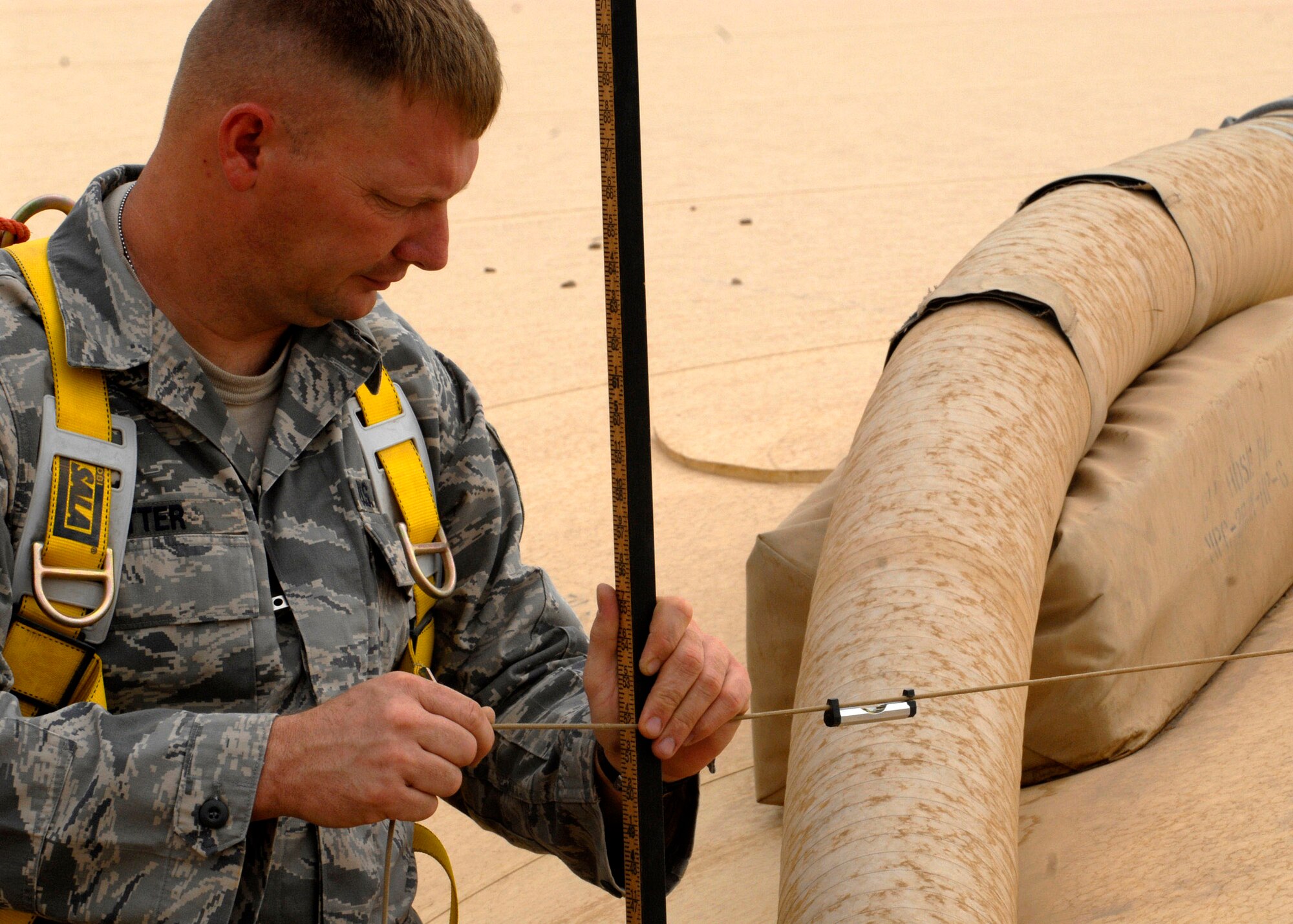 Tech. Sgt. Joseph Ritter measures the amount of fuel in a storage cell to monitor the fuel inventory Oct. 17 at Balad Air Base, Iraq. Sergeant Ritter is assigned to the 332nd Expeditionary Logistics Readiness Squadron. He is deployed from Little Rock Air Force Base, Ark., where he is a member of the 314th Logistics Readiness Squadron. (U.S. Air Force photo/Staff Sgt. Joshua Garcia) 
