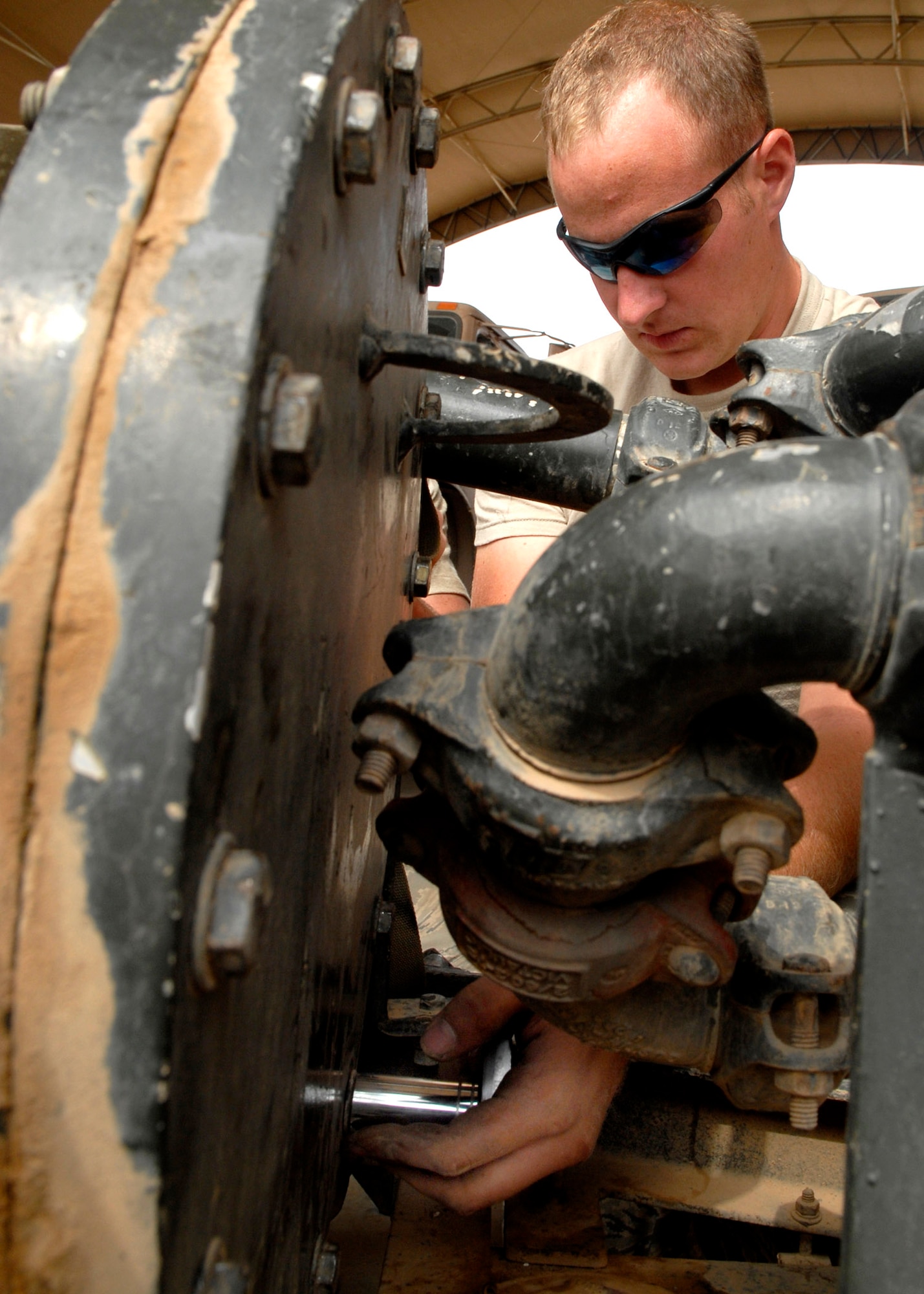 Senior Airman Justin Collins changes out the filter on a pumping unit Oct. 17 at Balad Air Base, Iraq. The pump is used to transfer fuel from storage cells to mobile refueling equipment. Airman Collins is assigned to the 332nd Expeditionary Logistics Readiness Squadron. He is deployed from Little Rock Air Force Base, Ark., where he is a member of the 314th Logistics Readiness Squadron. (U.S. Air Force photo/Staff Sgt. Joshua Garcia) 
