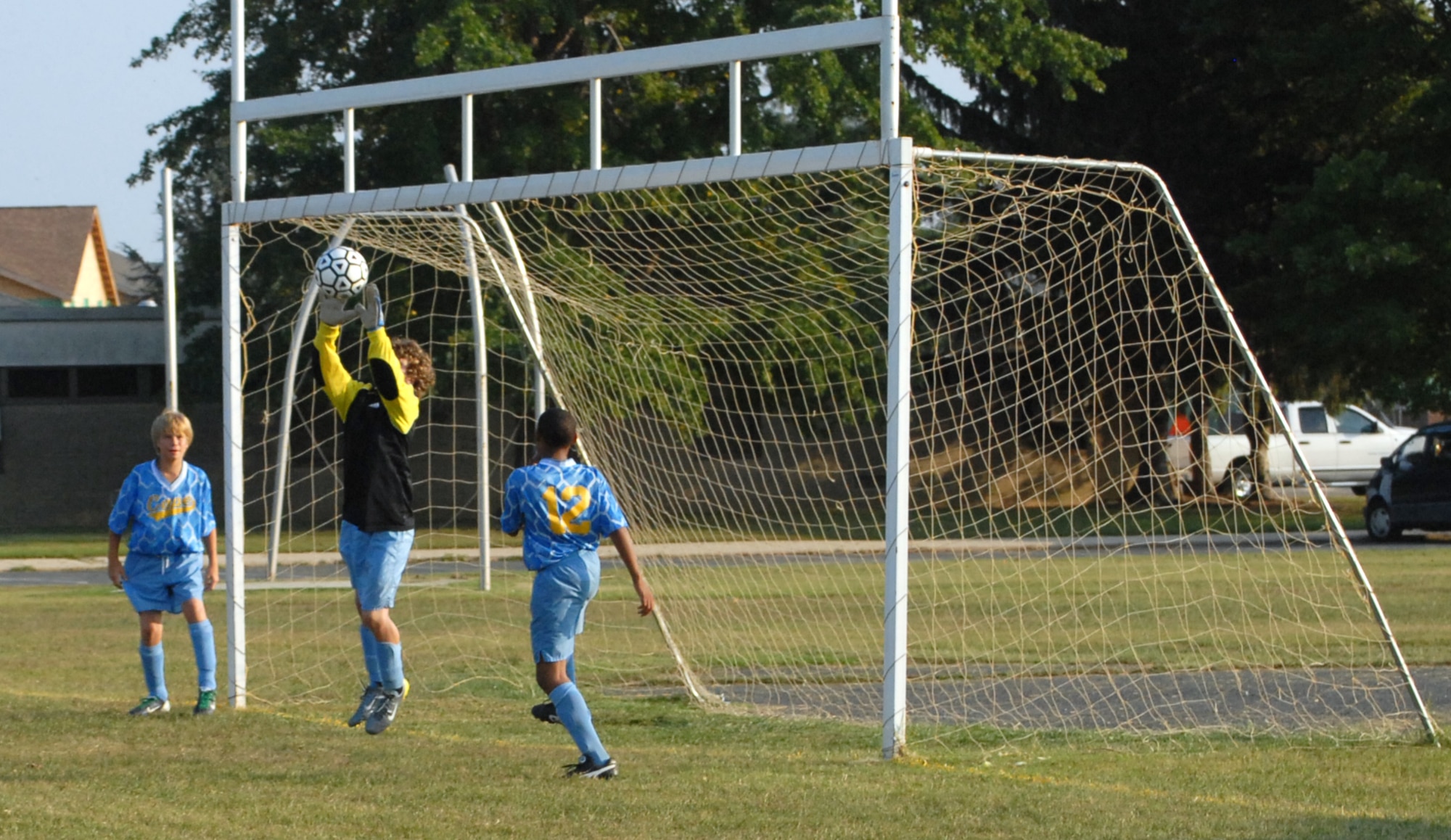 The Mariner Middle School goalkeeper leaps and reels in a shot at his goal as two defending full backs back up his play. Though relentless efforts were made to score, the Eagle’s offense could not penetrate the Cav’s defense. (U.S. Air Force photo/Tech. Sgt. Kevin Wallace)
