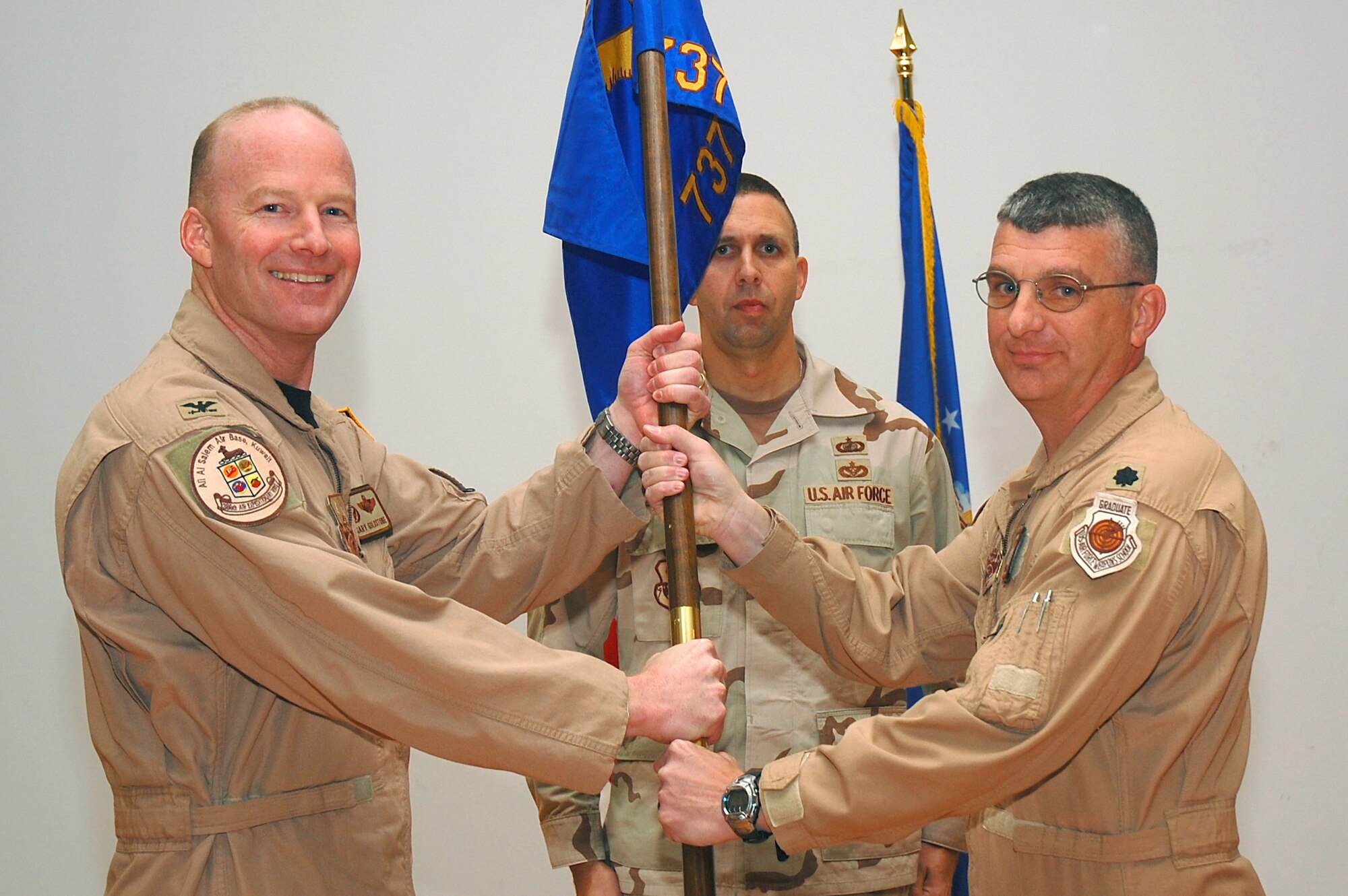 SOUTHWEST ASIA -- 737th Expeditionary Airlift Squadron change of command.  Lt. Col. Brian Yates assumes command of the squadron from Lt. Col. David Knight at an undisclosed location Oct. 17.  (U.S. Air Force photo by Staff Sgt. Tia Schroeder)