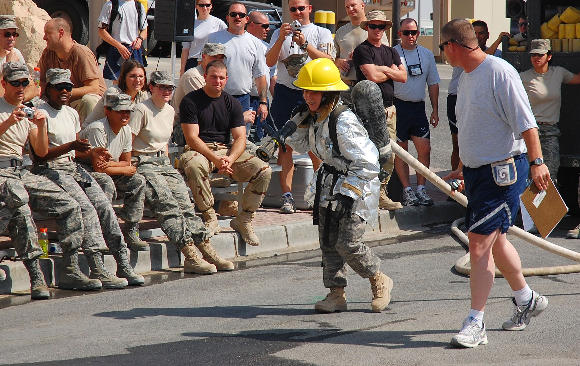 SOUTHWEST ASIA -- Staff Sgt. Kristen Coyne, 386th Expeditionary Civil Engineering Squadron emergency management, pulls a 40-pound hose 75 feet while participating in a firefighter challenge here Oct. 14.  Sergeant Coyle is deployed from 125th Air Refueling Wing, Great Falls, Mont.  (U.S. Air Force photo by Staff Sgt. Tia Schroeder)