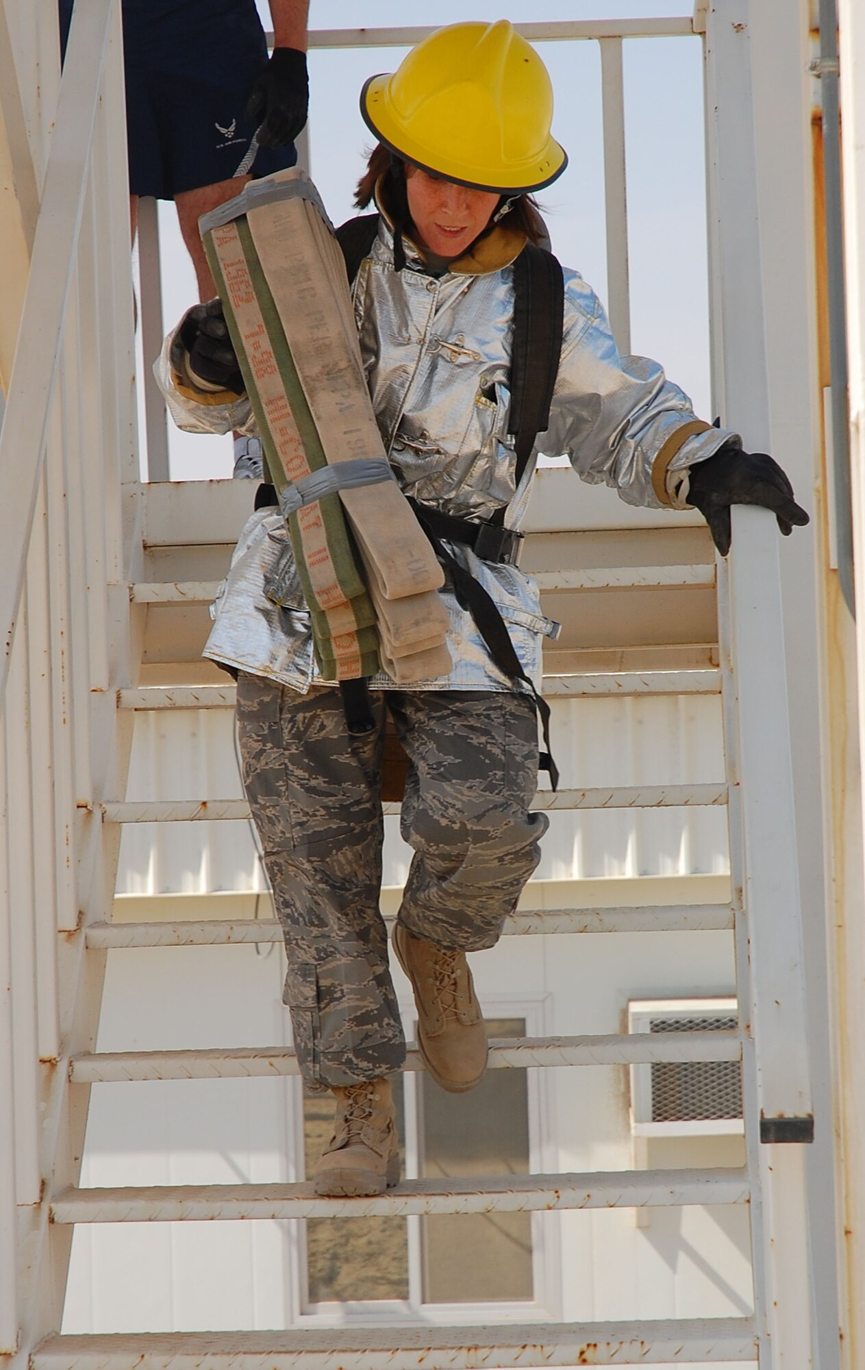 SOUTHWEST ASIA -- Staff Sgt. Kristen Coyne, 386th Expeditionary Civil Engineering Squadron emergency management, descends a 40-foot tower while participating in a firefighter challenge here Oct. 14.  Sergeant Coyle is deployed from 125th Air Refueling Wing, Great Falls, Mont. (U.S. Air Force photo by Staff Sgt. Tia Schroeder)
