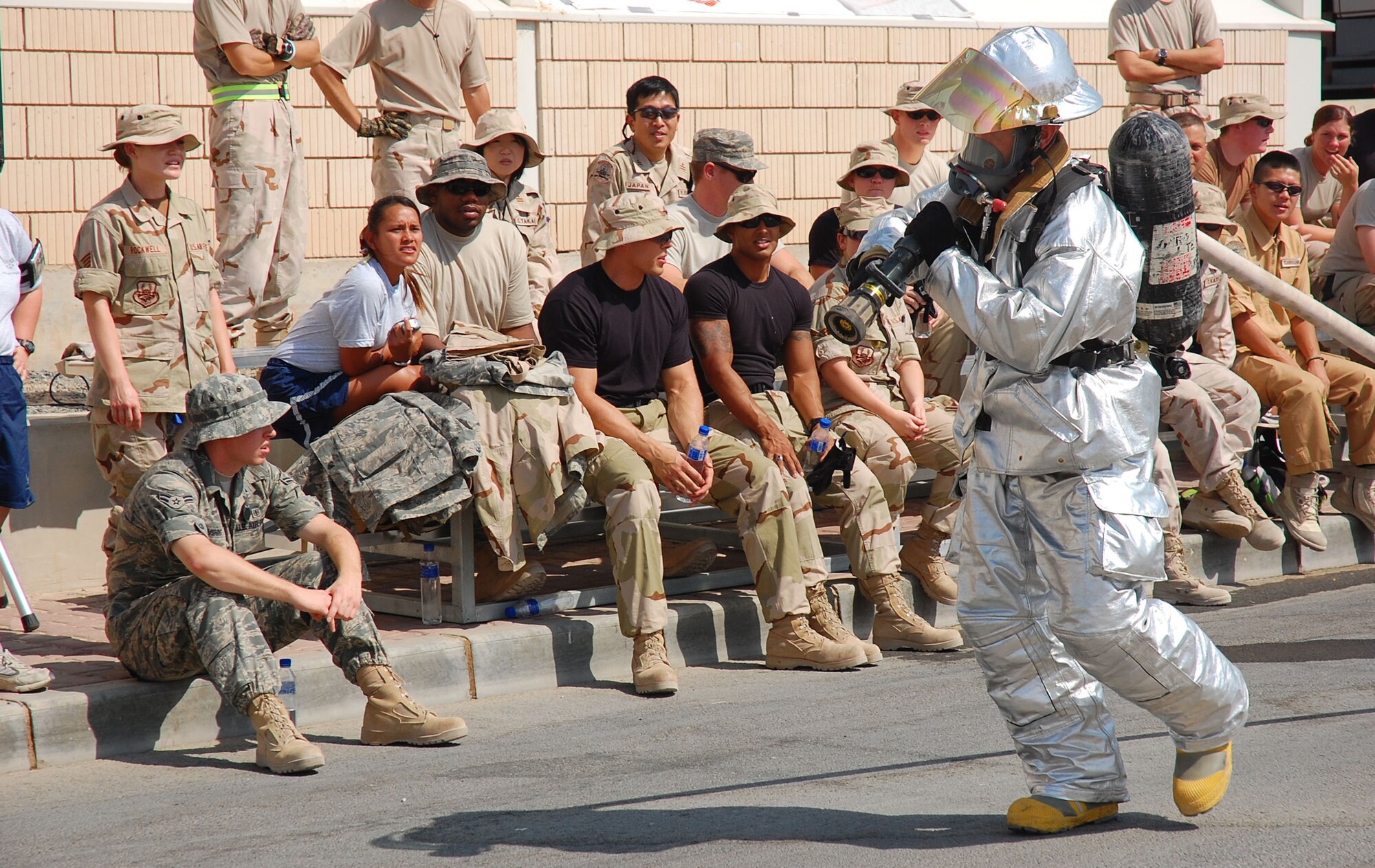 SOUTHWEST ASIA -- Senior Airman Nicholas Murdock, 386th Expeditionary Civil Engineering Squadron firefighter, pulls a 40-pound hose 75 feet while demonstrating a simulated fire rescue during the firefighter challenge here Oct. 14.  Airman Murdock is deployed from 121st Air Refueling Wing, Columbus, Ohio.  (U.S. Air Force photo by Staff Sgt. Tia Schroeder)