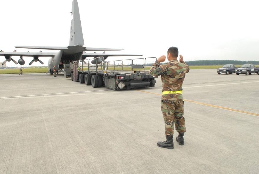 YOKOTA AIR BASE, Japan -- Members from the 374th Airlift Wing and the 730th Air Mobility Squadron participate load a C-130 Hercules in a practice humanitarian relief scenario. This scenario is part of Yokota's Operational Readiness Exercise taking place on October 16th, 2007. (U.S. Air Force photo by SrA John Albea) 