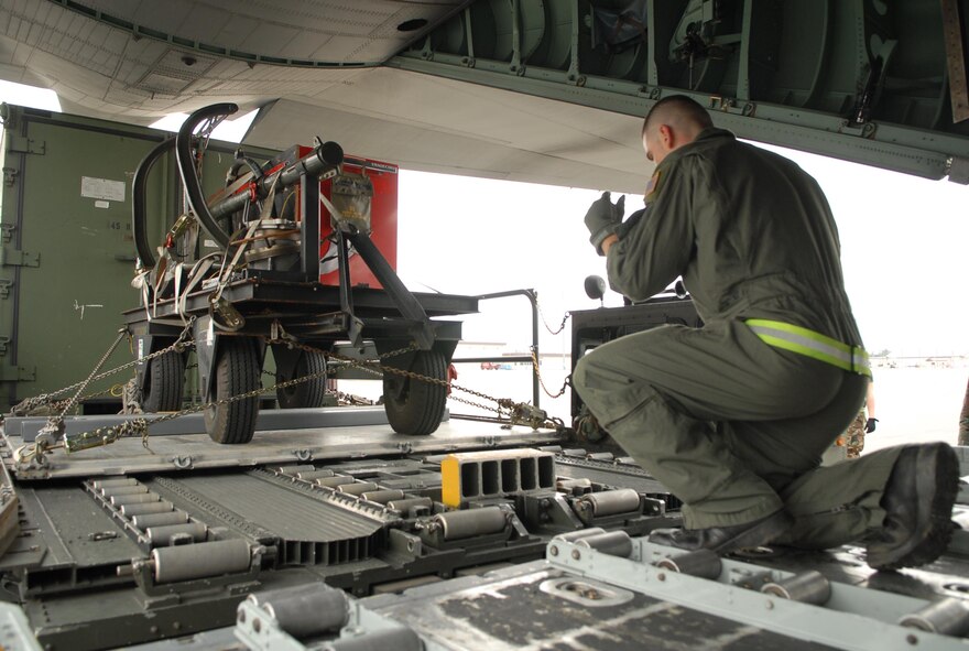 YOKOTA AIR BASE, Japan -- Members from the 374th Airlift Wing and the 730th Air Mobility Squadron participate load a C-130 Hercules in a practice humanitarian relief scenario. This scenario is part of Yokota's Operational Readiness Exercise taking place on October 16th, 2007. (U.S. Air Force photo by SrA John Albea) 