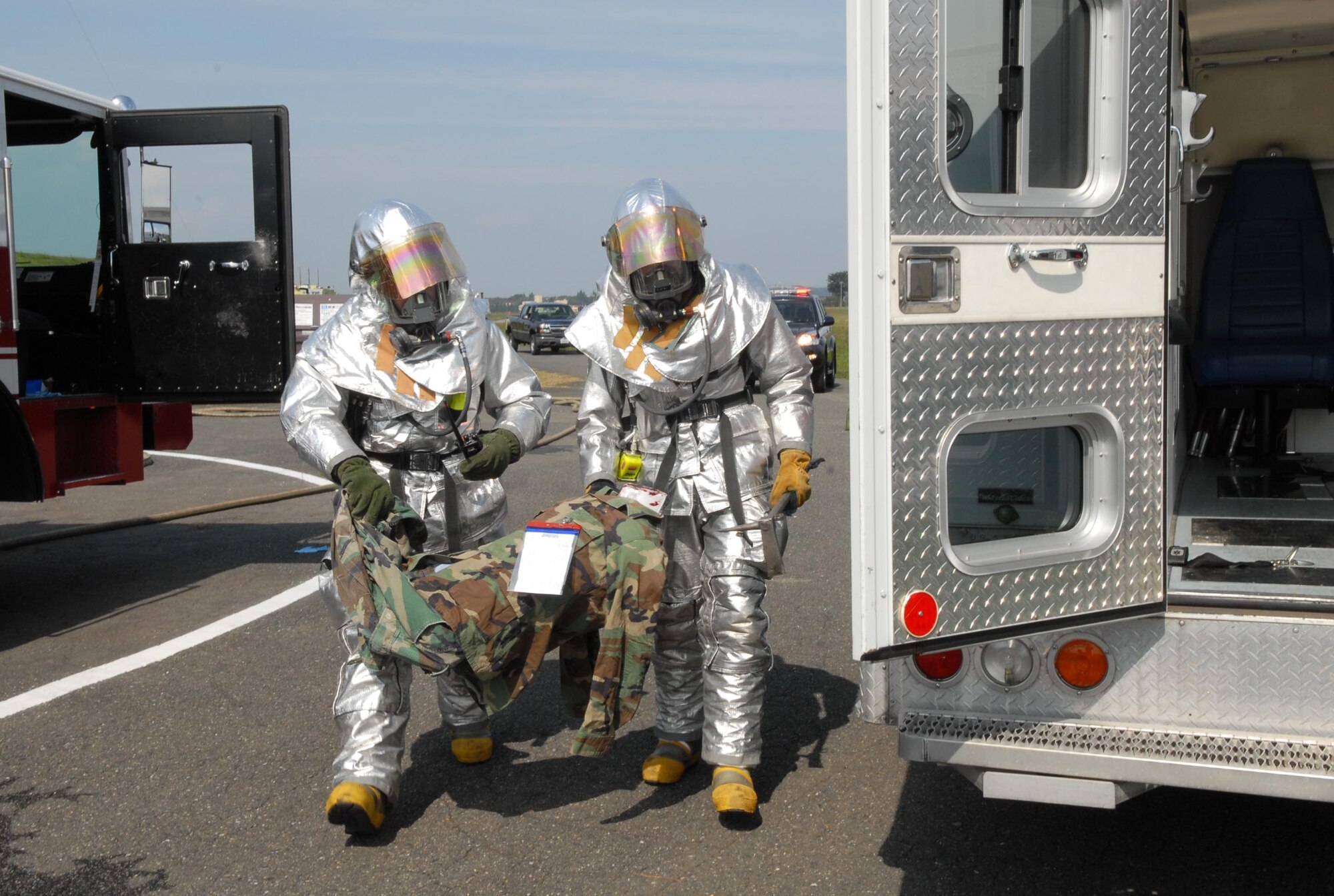 YOKOTA AIR BASE, Japan -- Members from the 374th Civil Engineering Squadron Fire Department takes part in a C-130 Hercules Egress. This scenario is part of Yokota's Operational Readiness Exercise taking place on October 16th, 2007. (U.S. Air Force photo by SrA John Albea)