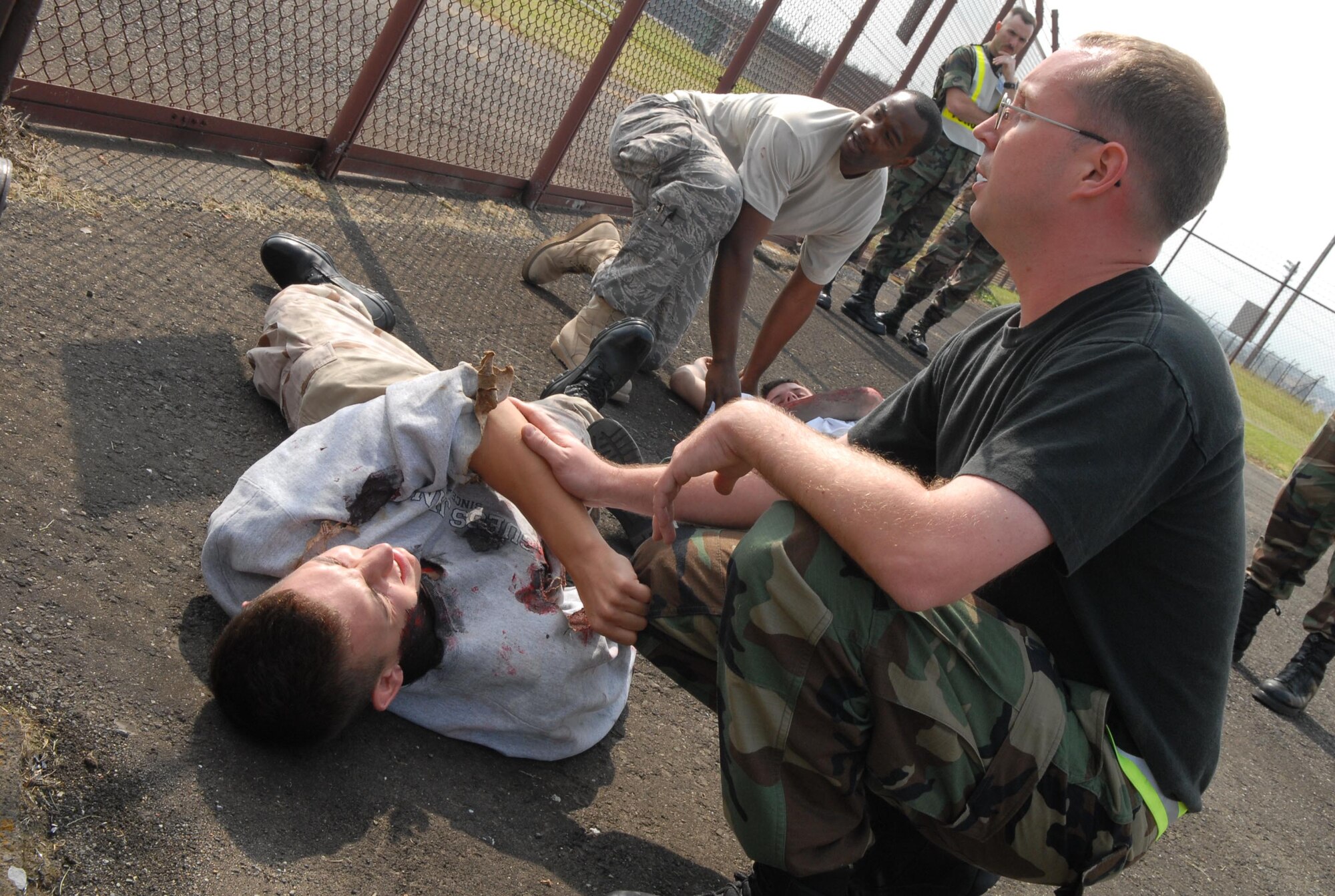 YOKOTA AIR BASE, Japan -- Members from the 374th Airlift Wing take part in a Self Aid Buddy Care scenario. This scenario is part of Yokota's Operational Readiness Exercise taking place on October 16th, 2007. (U.S. Air Force photo by SrA John Albea)