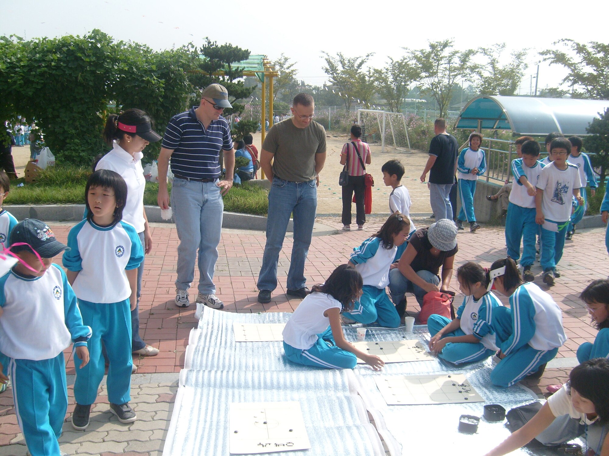 The Do-San Elementary School in Gwang Ju, ROK, invited personnel from Detachment 1, 607th Materiel Maintenance Squadron, to their annual Autumn Sports Day.  The students and Det 1 personnel participated in a variety of activities such as tug-of- war, wheel and stick, and the traditional Korean see-saw. Det 1 members are no strangers to the local community.  Since September 2006, members have volunteered to teach English to the children at Do-San Elementary three times a month as part of the Good Neighbor Program.  Activities like this greatly improve the students’ English ability, help foster a good relationship with the local Gwang Ju community, and also give our detachment members an experience they will never forget. (photo by Ki Hyun Pak ) 