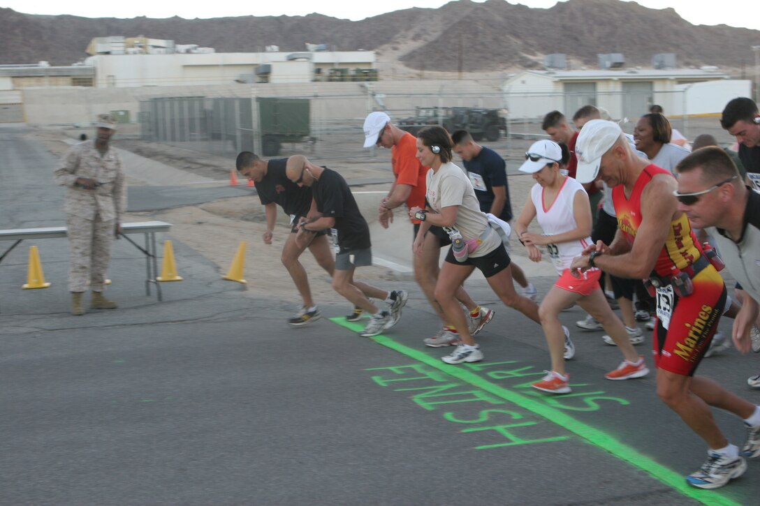 Runners start their stopwatches as they take off from the starting line in front of Combat Center building 1831 and kick off the 4th Marine Corps Communication-Electronics School Fun Run Oct. 19.