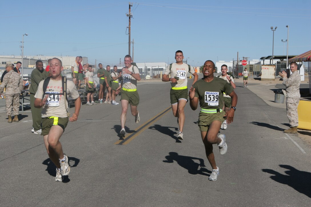The 4th Marine Corps Communication-Electronics School Fun Run participants stretch it out and sprint to the finish line of the half-marathon in front of Combat Center building 1831 Oct. 19.
