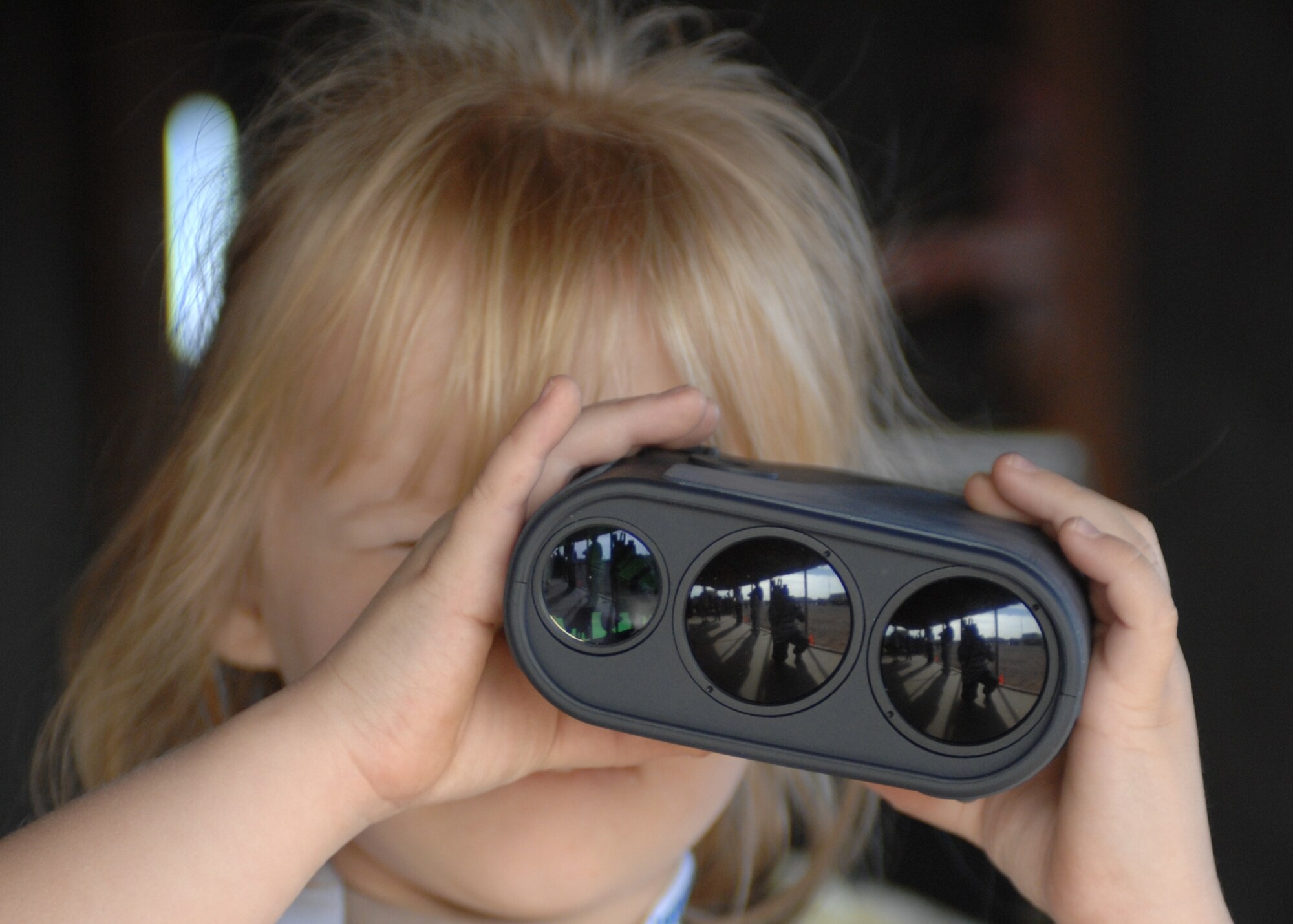 Una Groover, 5, spies through a laser range finder during Operation KIDS Oct.13. (photo by Tech. Sgt. Raheem Moore)