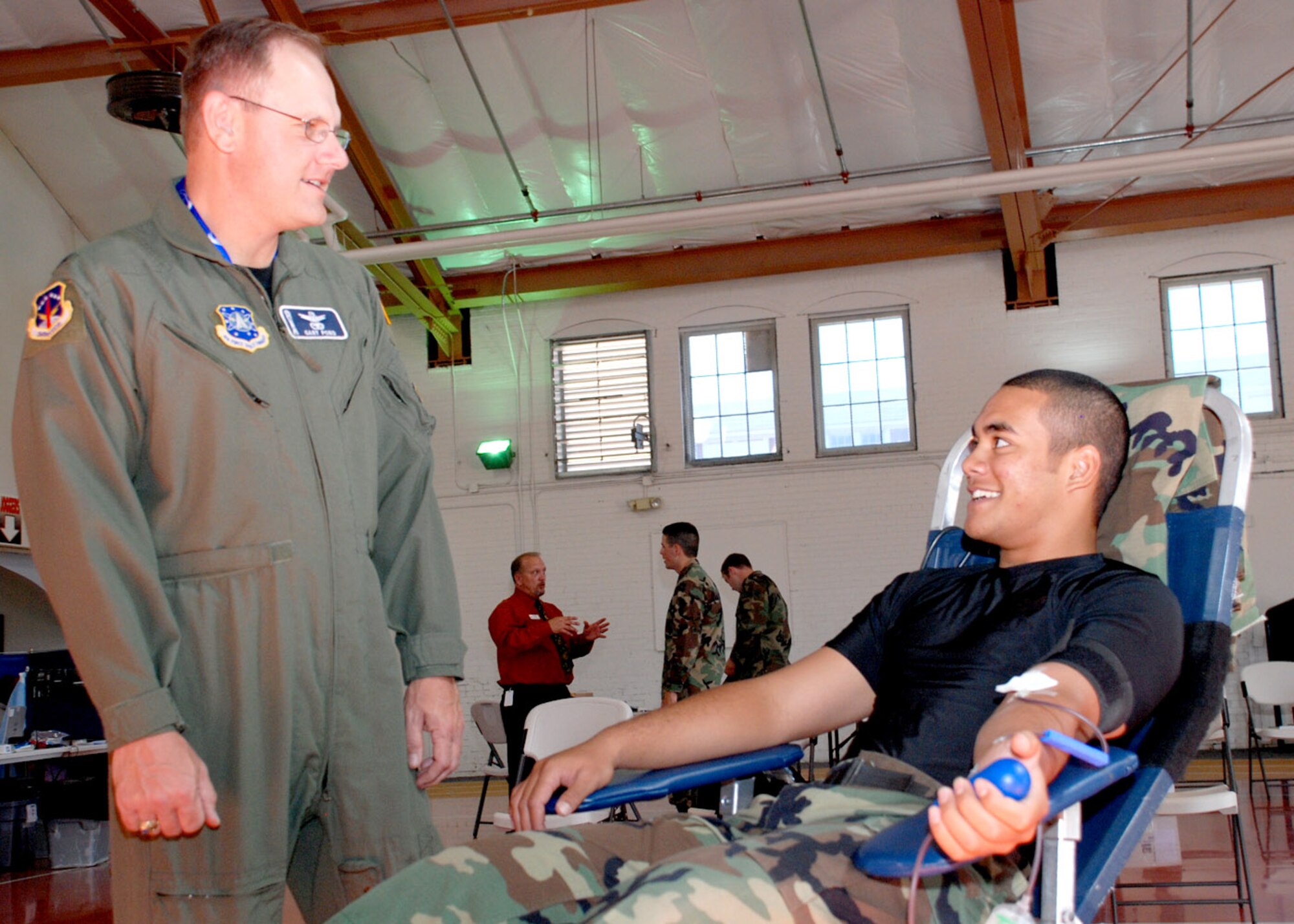 Col. Gary Pond, 90th Space Wing vice commander, shows his appreciation to Airman 1st Class Gabriel Time, 90th Force Support Squadron, during Oct. 11 blood drive. This is Airman Time’s fourth blood donation (Photo by Airman 1st Class Daryl Knee).