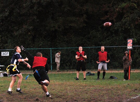 From left, Air Force Research Laboratory flag football team member jumps to catch the ball as a player from the 653rd Electronic Systems Wing tries to defend during the Intramural Flag Football Championship game on base Oct. 15.  AFRL defeat 653 ELSW 13-6. (U.S. Air Force photo by Dennis Lewis)
